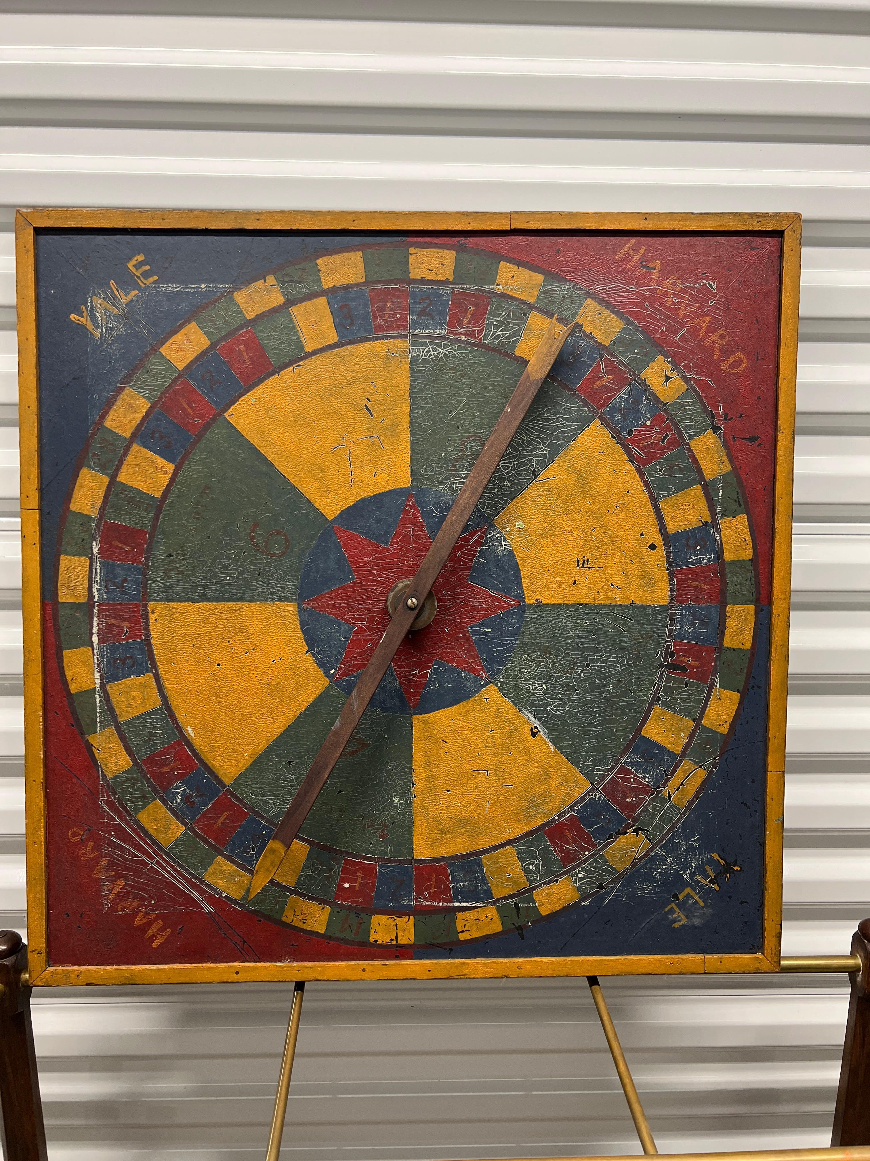American, circa 1900.

A highly unusual American folk art game board. Hand designed and painted likely in New England by an Ivy Leaguer which features a 4 corner 
