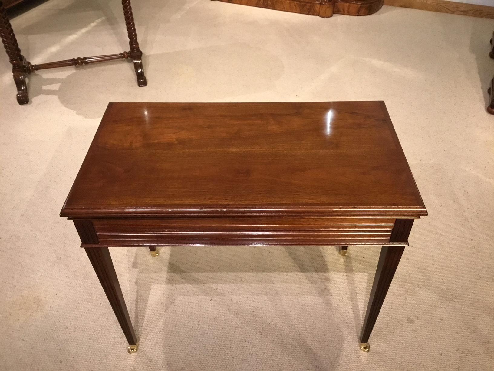 A highly unusual and rare walnut Edwardian period metamorphic games/chess/roulette and backgammon table. Having a rectangular solid walnut top lifting off and revealing on the underside an inlaid chess and draughts board. Also incorporated in the