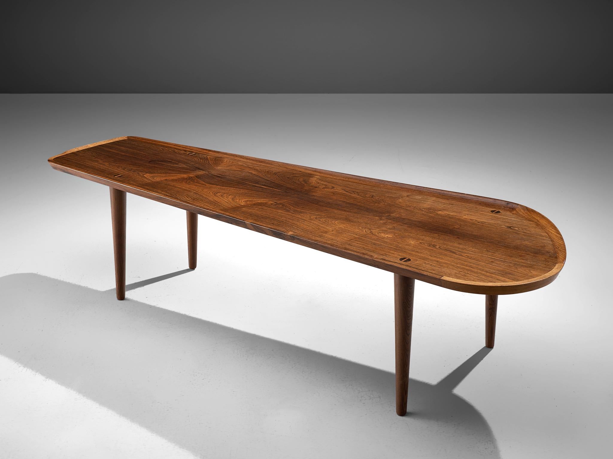 Freeform rosewood coffee table, Denmark, 1960s by the known designer Arne Hovmand-Olsen.

This organically shaped coffee table is well made in rosewood, and shows elegant details and outstanding craftsmanship. The upstanding edge of the top is