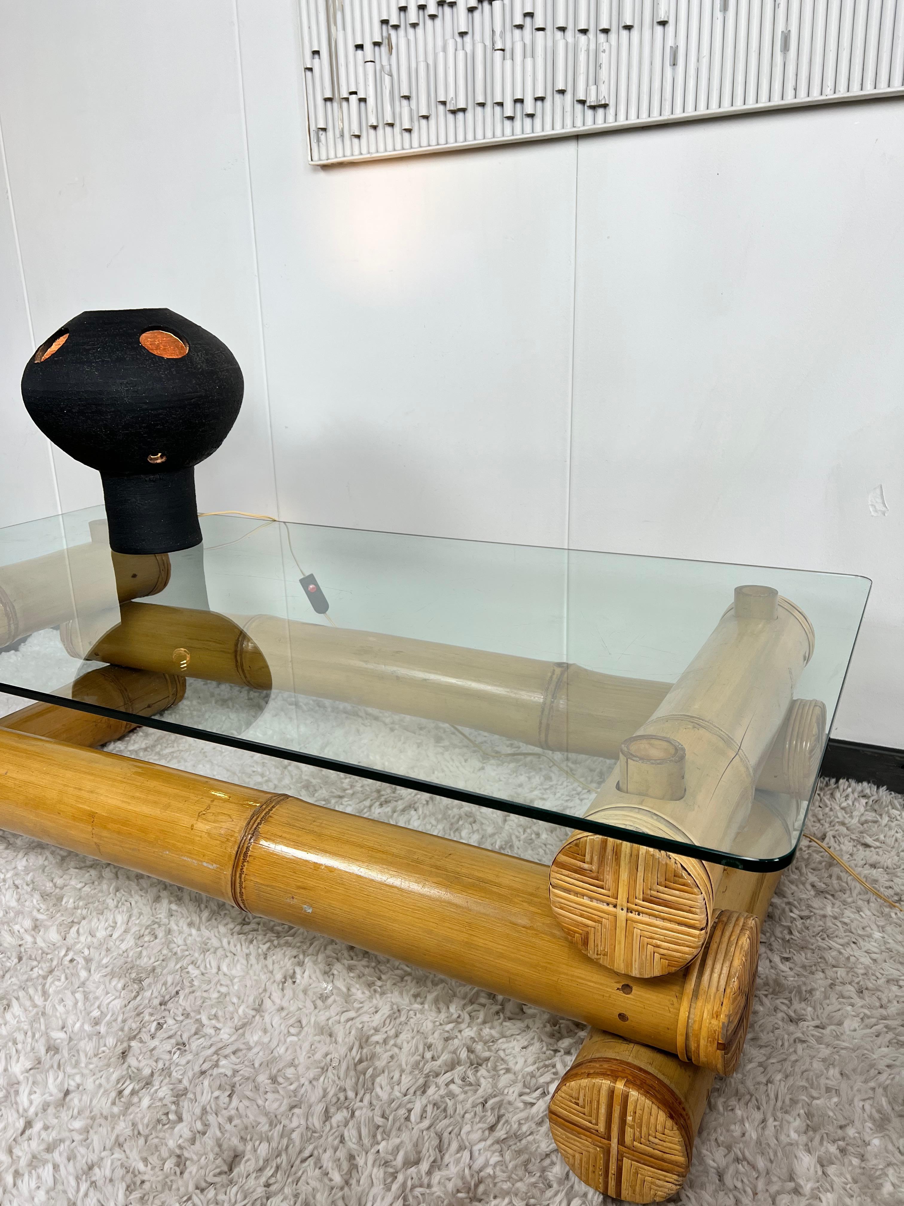 Highly unusual bamboo coffee table with glass top. The base is formed by stacked bamboo stems, each about 15cm thick! No nails or screws were used, just wooden pins. The thick clear glass top rests on the bamboo and has rounded corners.
 
Hard to