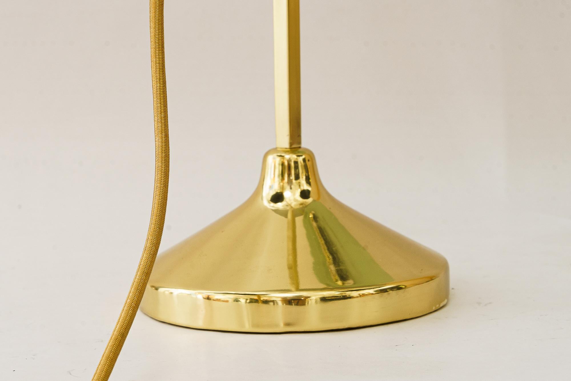 Hight adjustable and swiveling Art Deco Table lamp with glass shade vienna around 1920s
Brass polished and stove enameled

