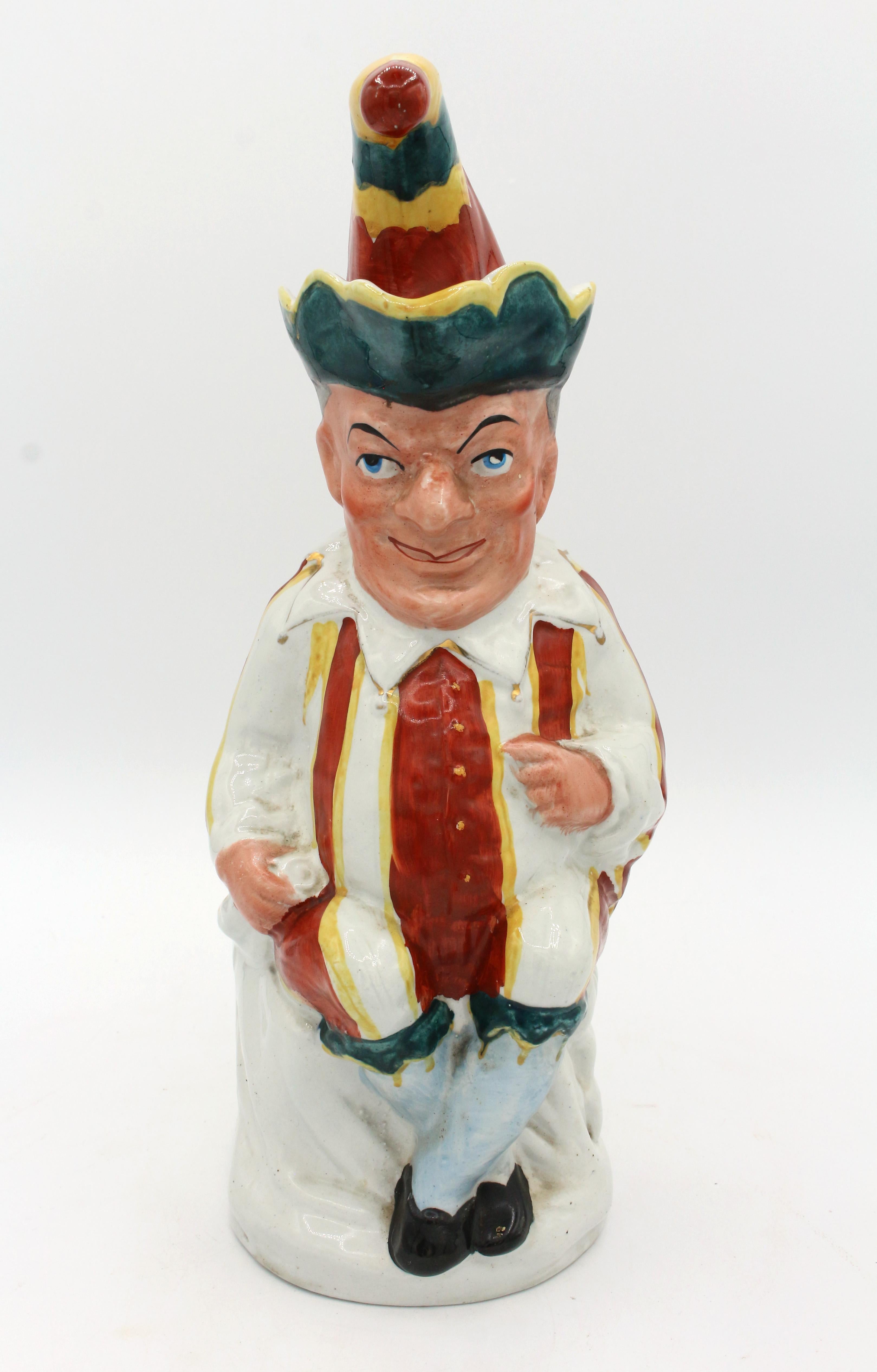 A hilarious Punch figure Toby Jug by William Machin, England, 1889-1910. Hawley, Staffordshire. Impressed registration number 