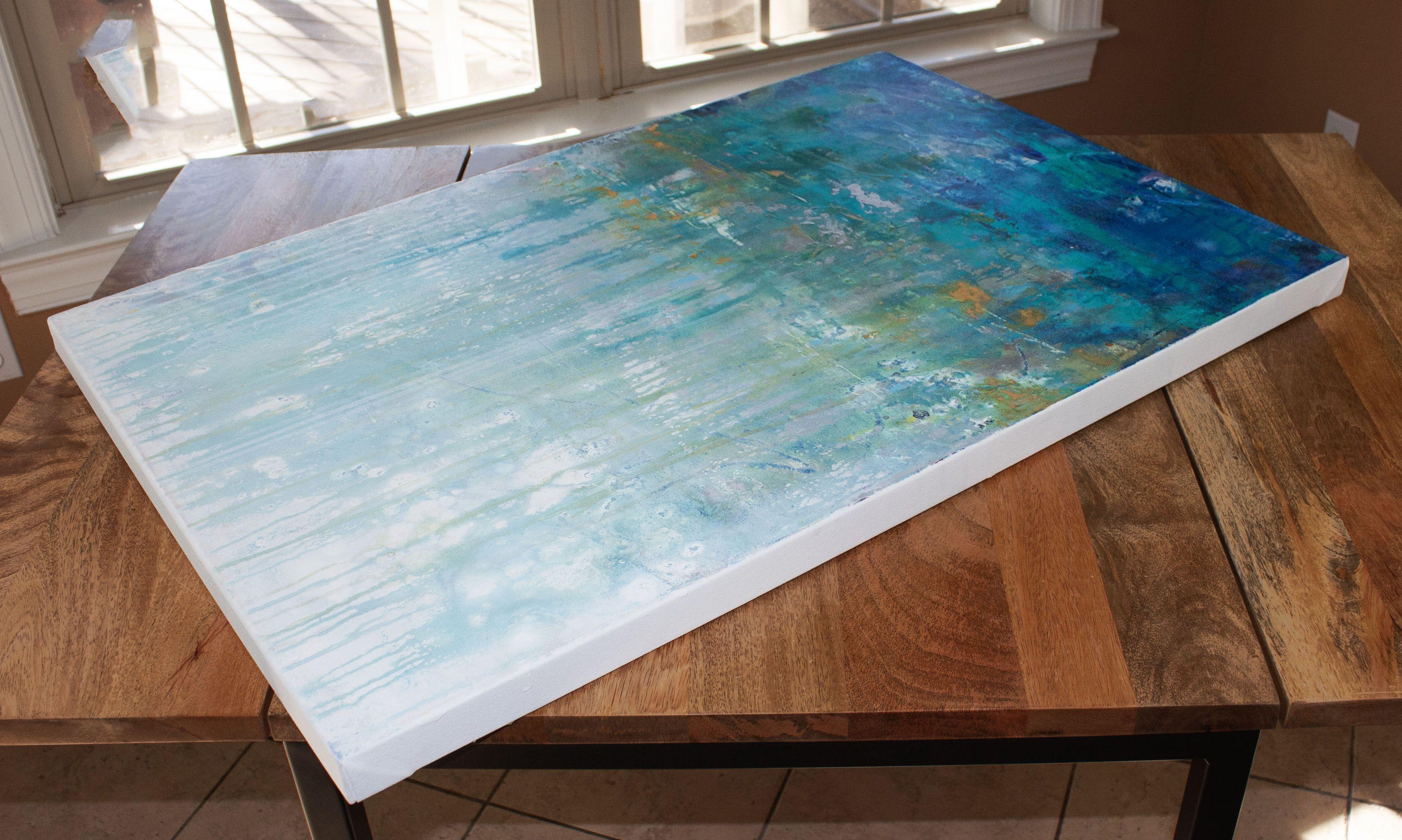 Asthenosphere 9 is an original painting, created with acrylic paint on gallery-wrapped canvas. It has a width of 36 inches and a height of 24 inches with a depth of 1.5 inches (36x24x1.5). The colors used in the painting are white, blue, teal, red,