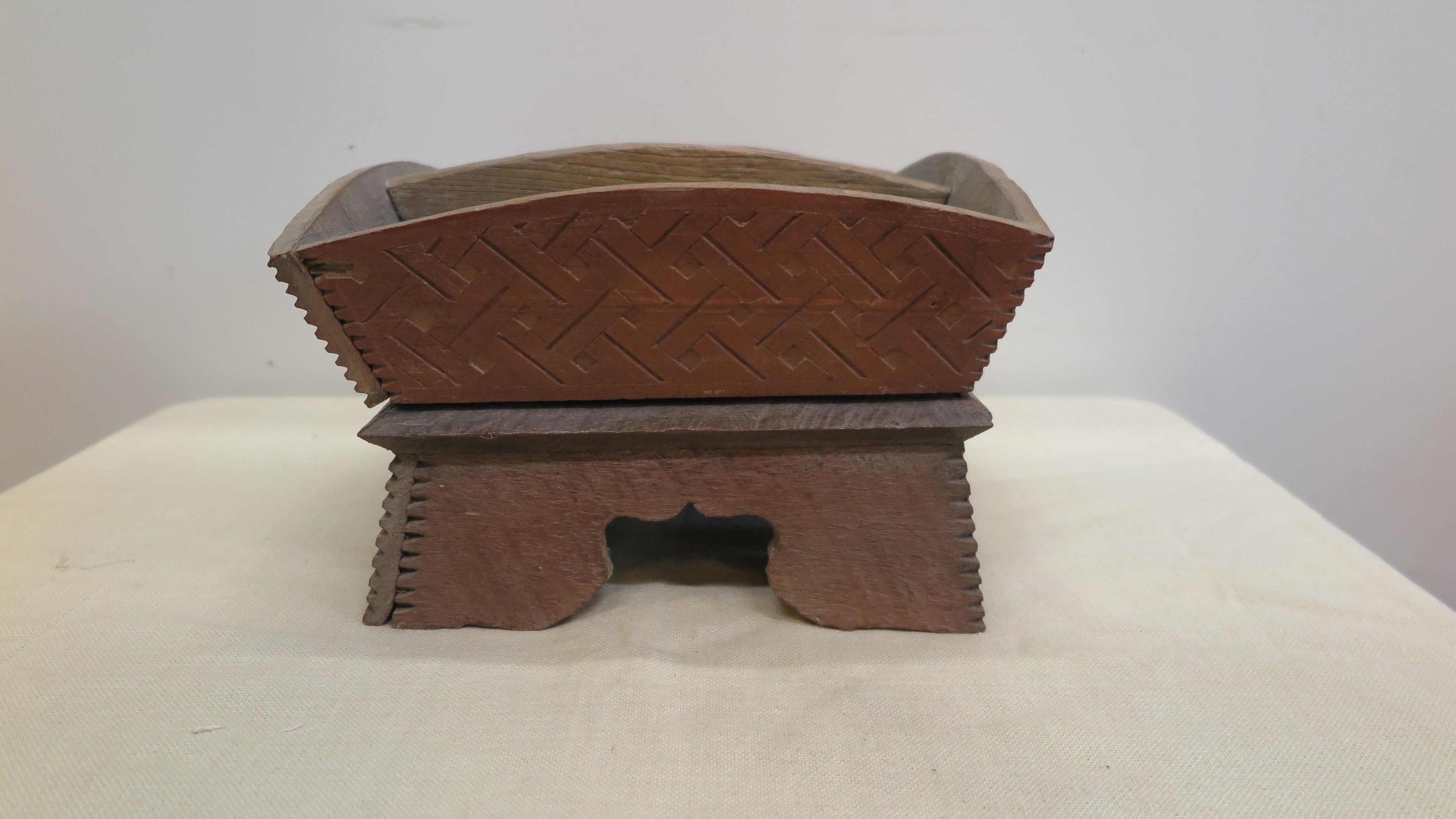A betel nut box. Hill Tribe Betel Nut Box, from the Hill Tribes that live amongst Thailand and Loa borders in the mountain hills. Hand made of hard wood with geometric incised carved decoration. A beautiful tribal folk art box originally used in the