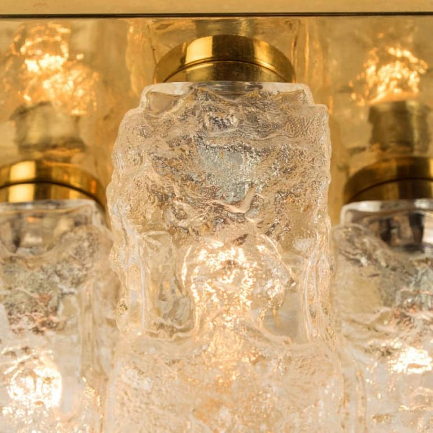 Flush light with Brutalist ice glass on a brass frame, circa 1970s, German. Often attributed to J.T. Kalmar this design was actually produced by Hillebrand Lighting of Germany.

Cruciform design flush mount light with four structured glass shades