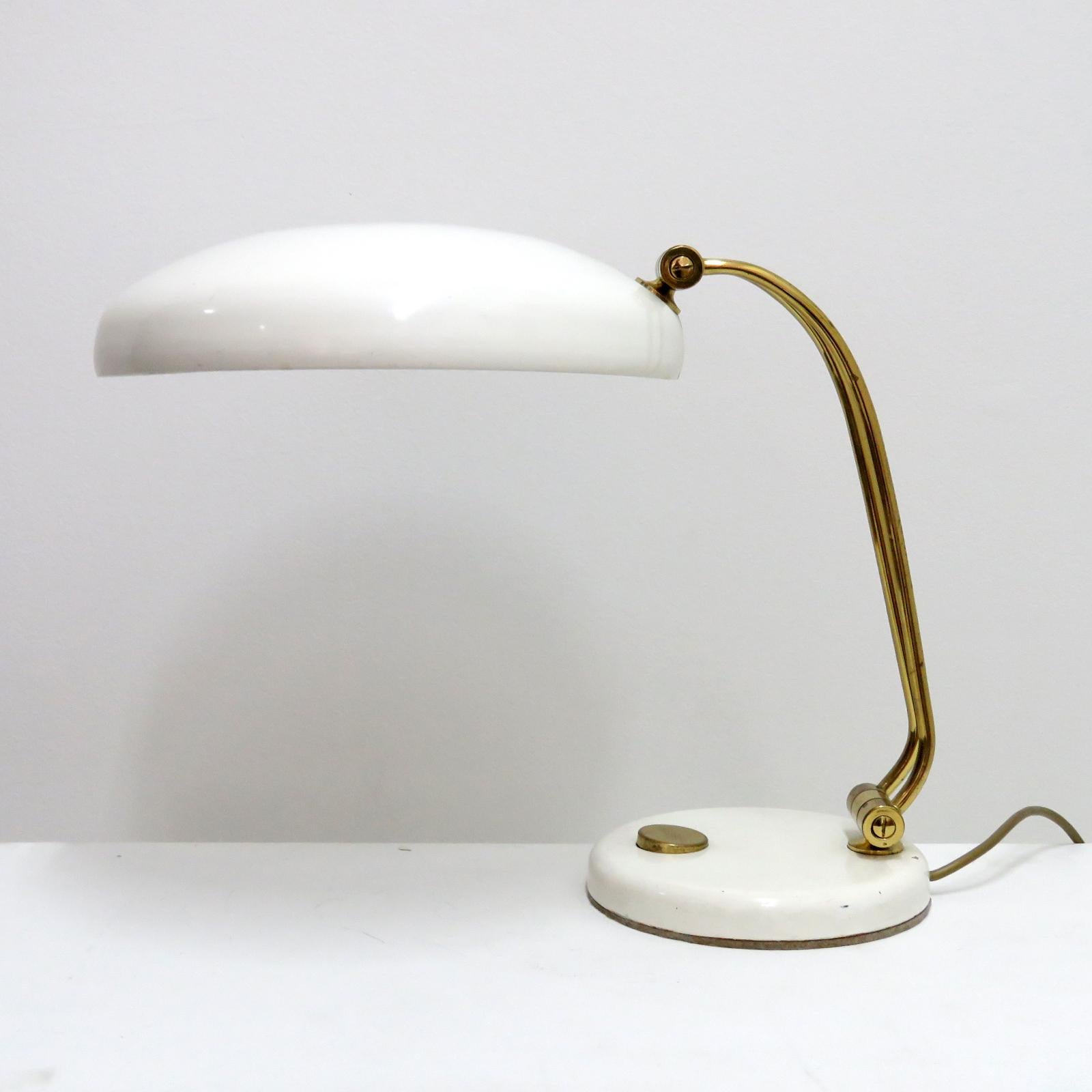 Wonderful table lamp by Hillebrand, 1960, in white and brass, on/off switch at the base, shade and arm are adjustable, wired for the US standards, one E27 socket, max. wattage 75w or LED equivalent, bulb provided as a onetime courtesy.