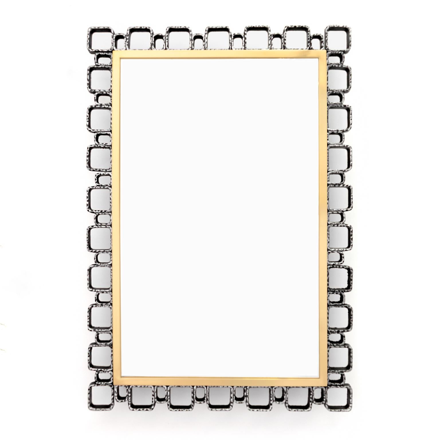 European Mid-Century Modern wall mirror with built in lights. The mirror’s frame is constructed of cast metal elements in the “Brutalist” aesthetic which surrounds a polished and lacquered brass inner frame. Newly restored, cleaned and polished,