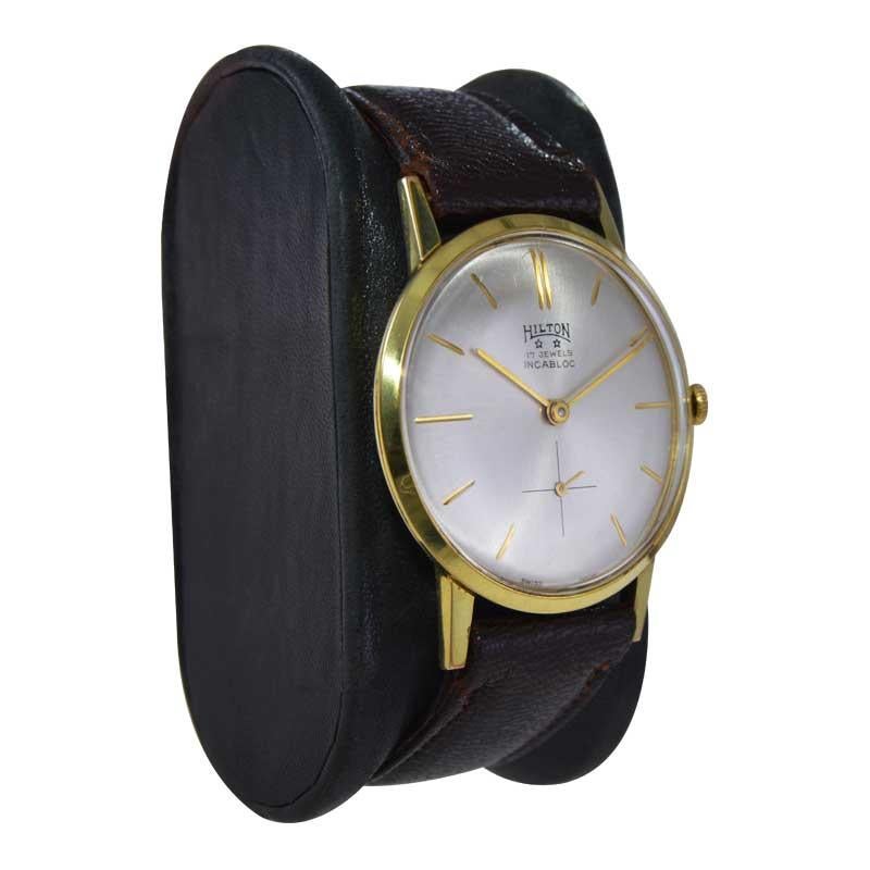 FACTORY / HOUSE: Hilton Watch Company
STYLE / REFERENCE: Modern / Round 
METAL / MATERIAL: Yellow Gold Filled 
CIRCA / YEAR: 1960's
DIMENSIONS / SIZE: Length 41mm X Diameter 34mm
MOVEMENT / CALIBER: Manual Winding / 17 Jewels / Pesaux 330
DIAL /