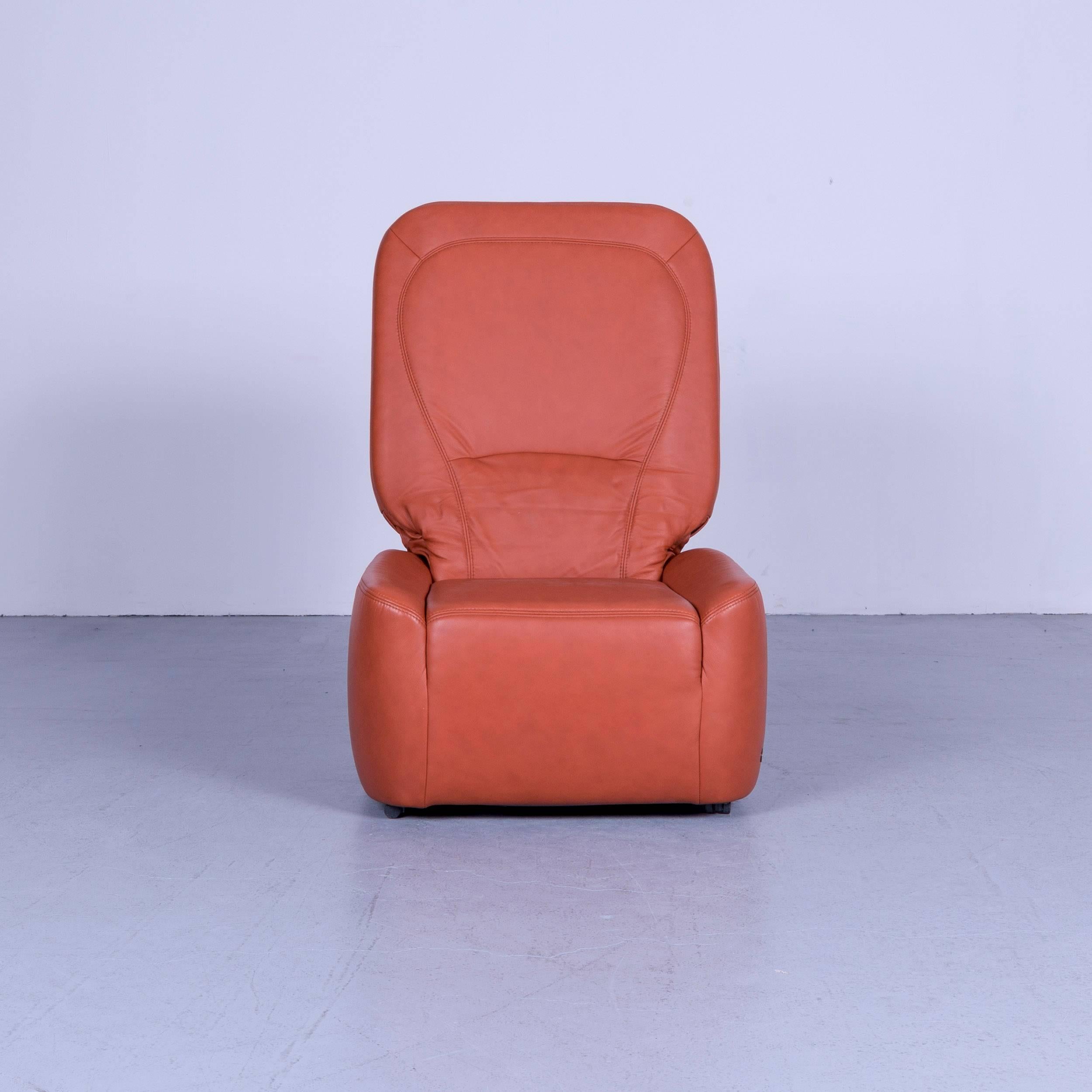 Orange colored Himolla foot stool made of leather convertible to a chair.