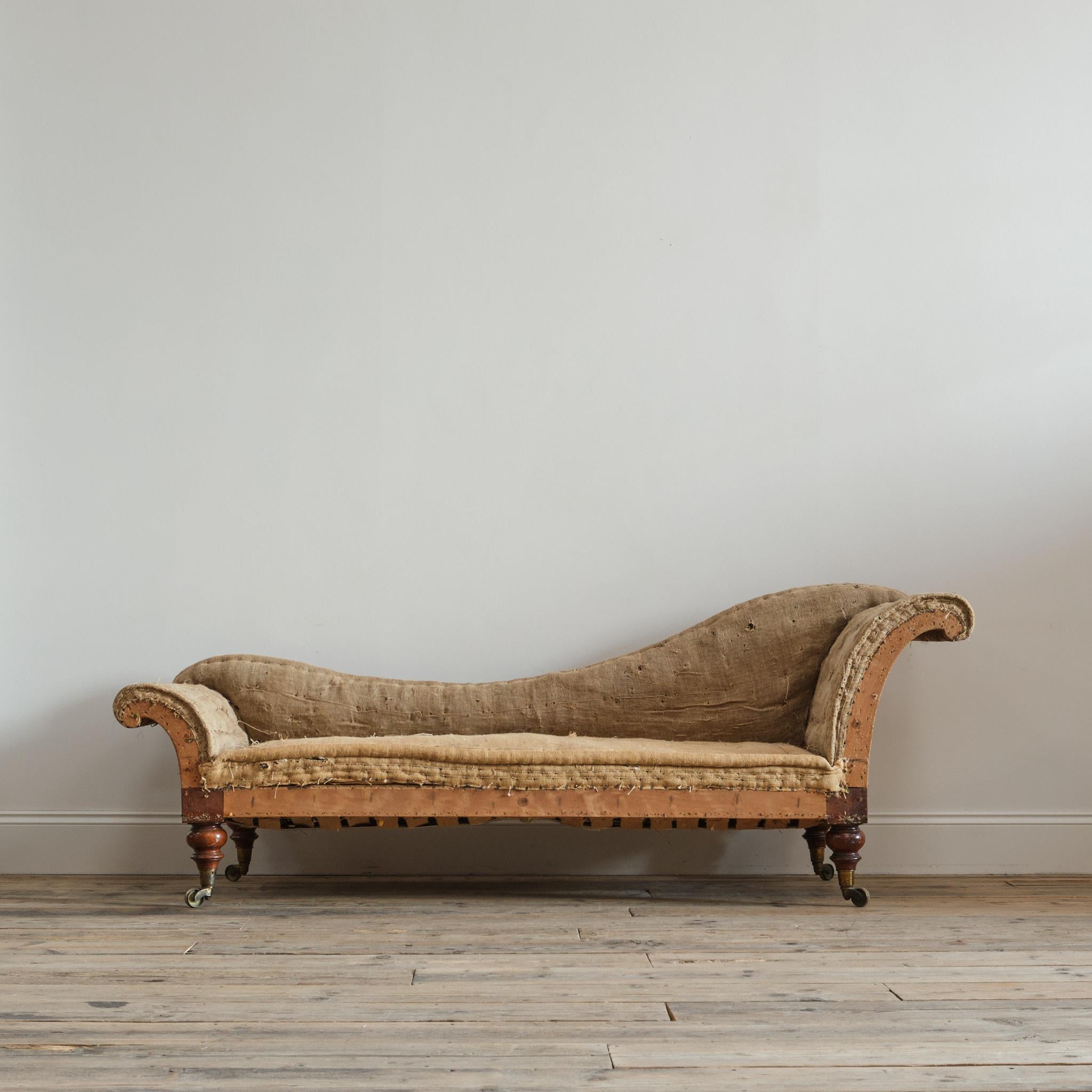 A mid 19th century Sofa Chaise longue by Hindley & Sons of 143 Oxford Street - London c1860. Raised on 4 turned walnut legs with the original gilt brass casters. 

Retaining the original innards to the arms and back. The seat is a recent replacement