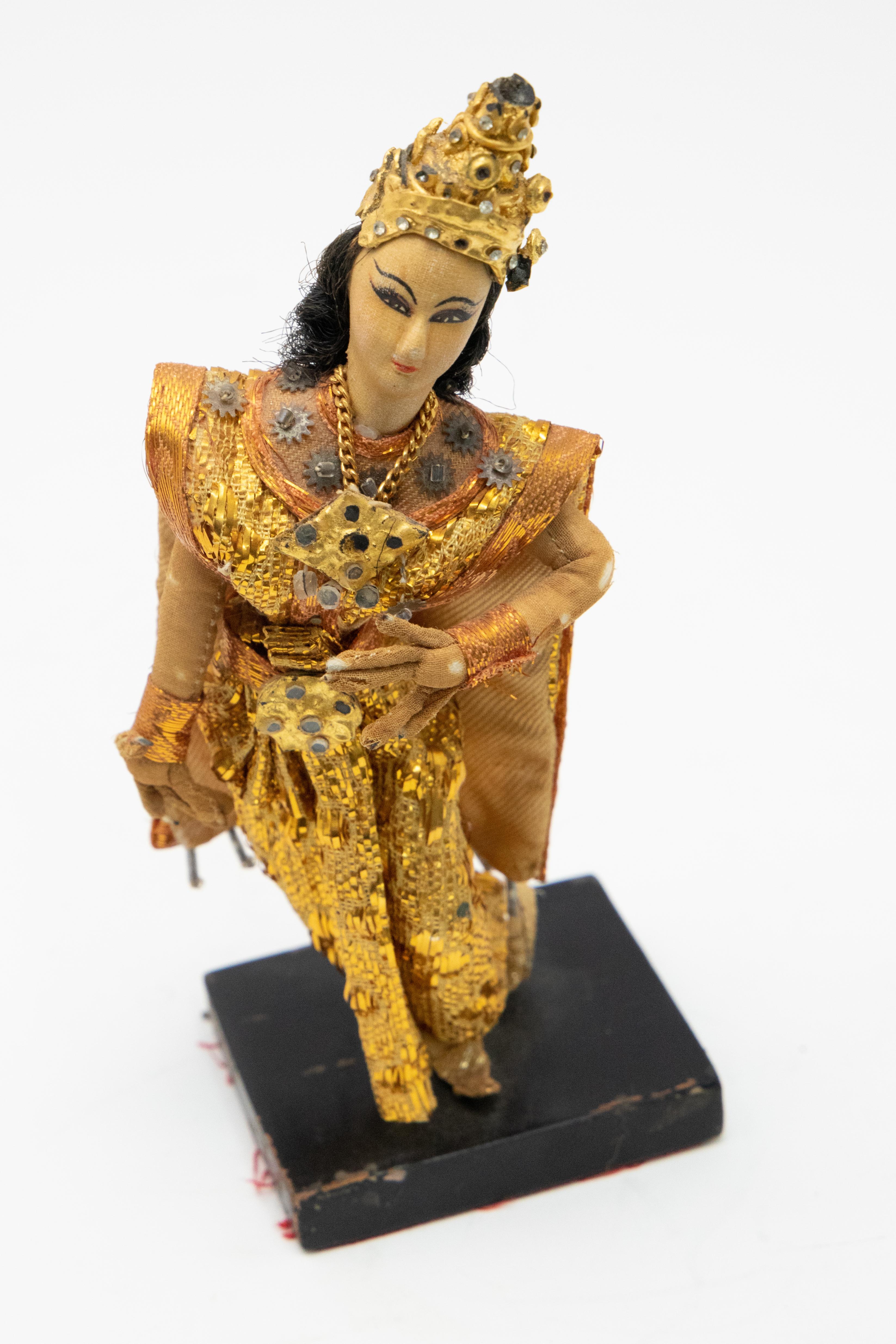Beautiful Hindu goddess doll all handmade. Wearing gorgeous robes with golds and coppers and a head piece. She stands on a wooden base.