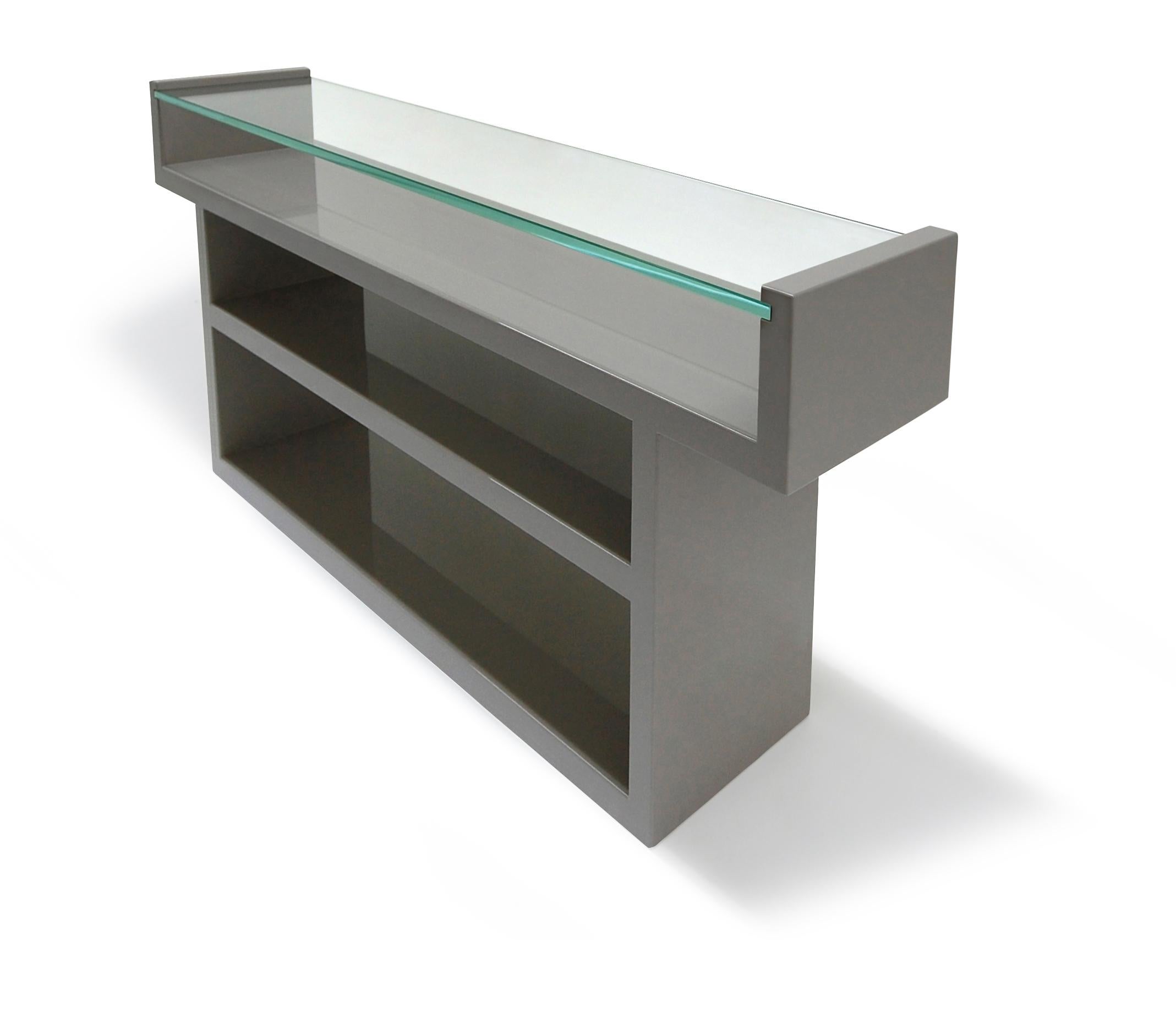The stunning Hinge Console is a harmonious balance between its sleek sophisticated glass top and the strong lacquer frame into which it is set. Clean lines and strong angles of this Hinge Console make this a bold choice for any space.

Glass: