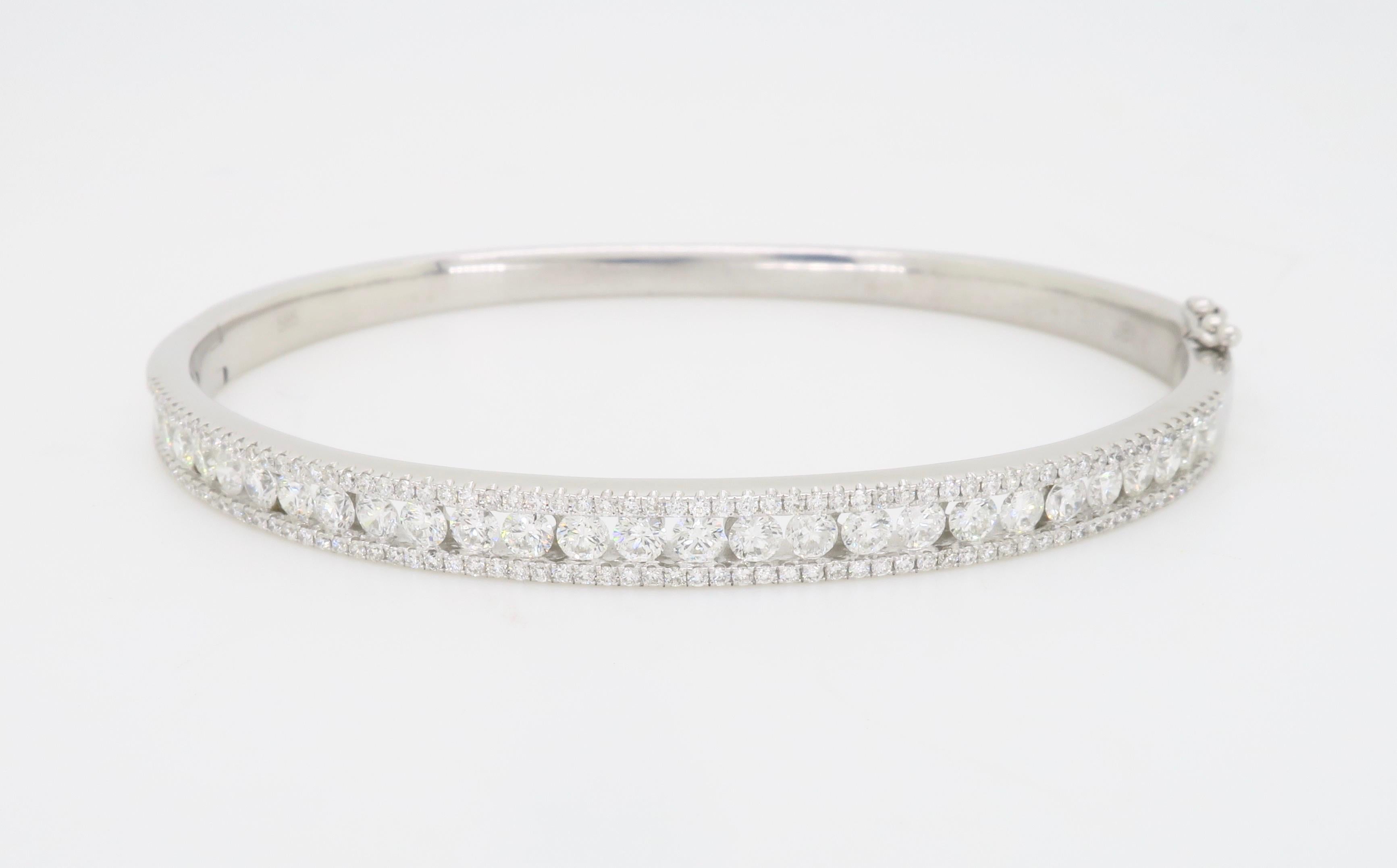 Hinged Diamond bangle bracelet crafted beautifully in 14k white gold. 

Diamond Carat Weight: Approximately 2.00CTW
Diamond Cut: Round Brilliant Cut 
Color: Average F-H
Clarity: Average VS-SI
Metal: 14K White Gold
Marked/Tested: Stamped  “585