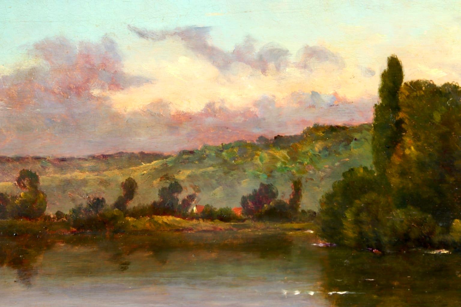 A charming oil on panel circa 1880 by sought after French Barbizon painter Hippolyte Camille Delpy. The piece depicts a view of the banks of the River Seine, with lush green trees and clouds illuminated in pinks and yellows contrasting against the