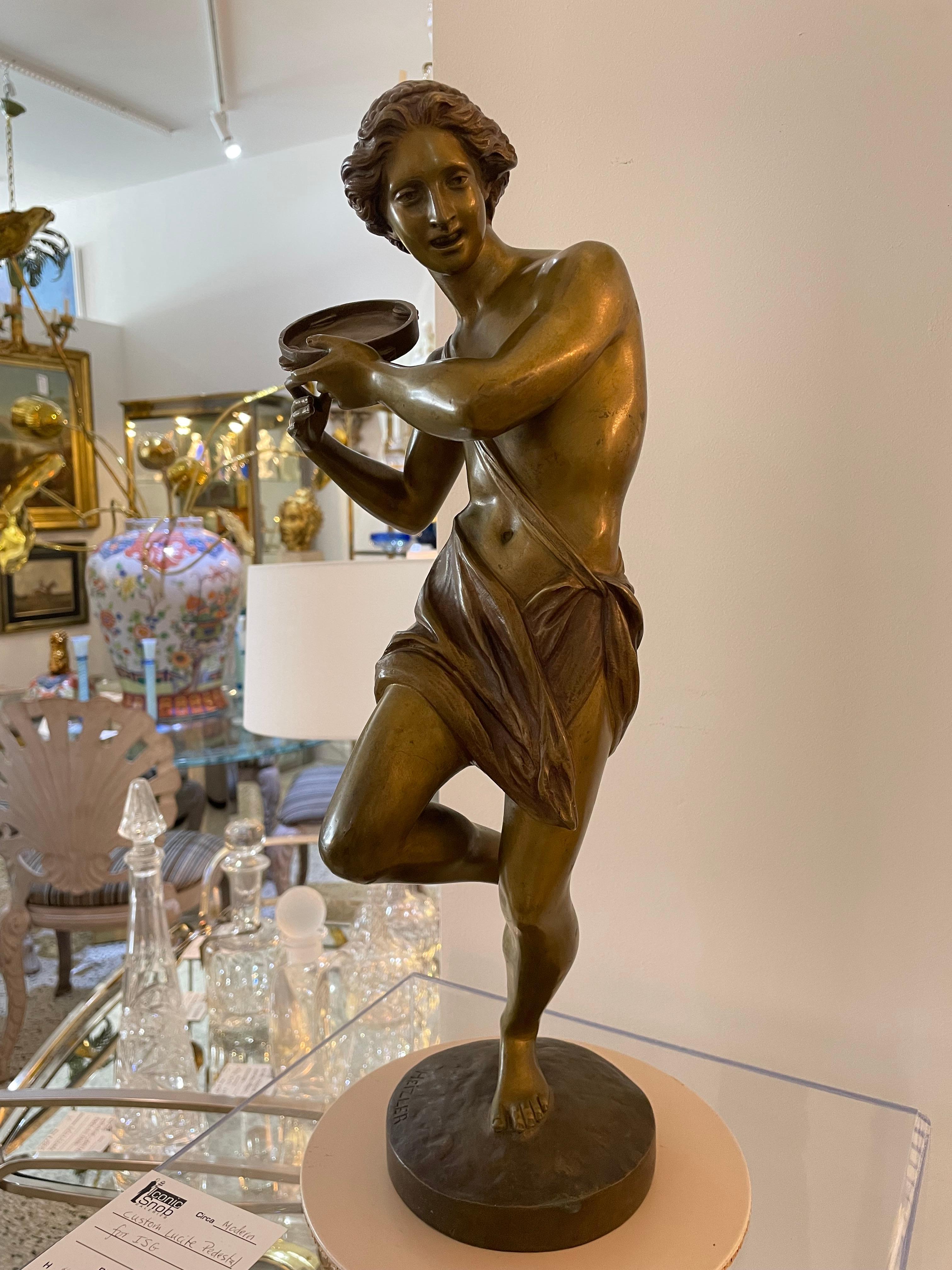 This stylish bronze figure of a tambourine player dates to the 1860s and was created by Hippolyte Heizler. 

Note: The piece is signed on the base.