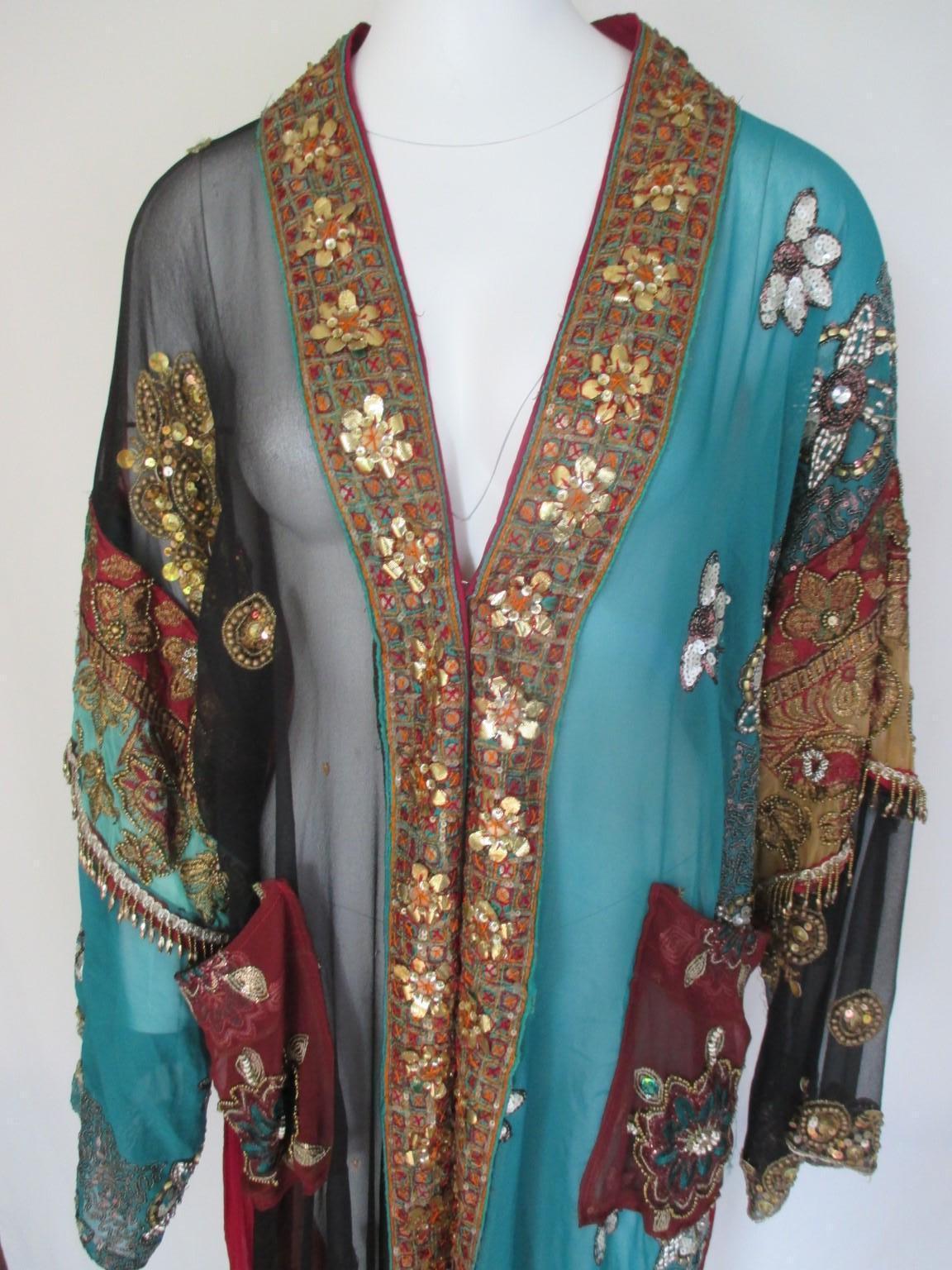 Unique hand made one- off a kind vintage colorful robe manteau.

We offer more excluisive items, view our frontstore

 Embroidered with sequins and vintage Indian pieces gold brocade , 2 pockets and a matching belt.
Can be worn over jeans, bikini, a