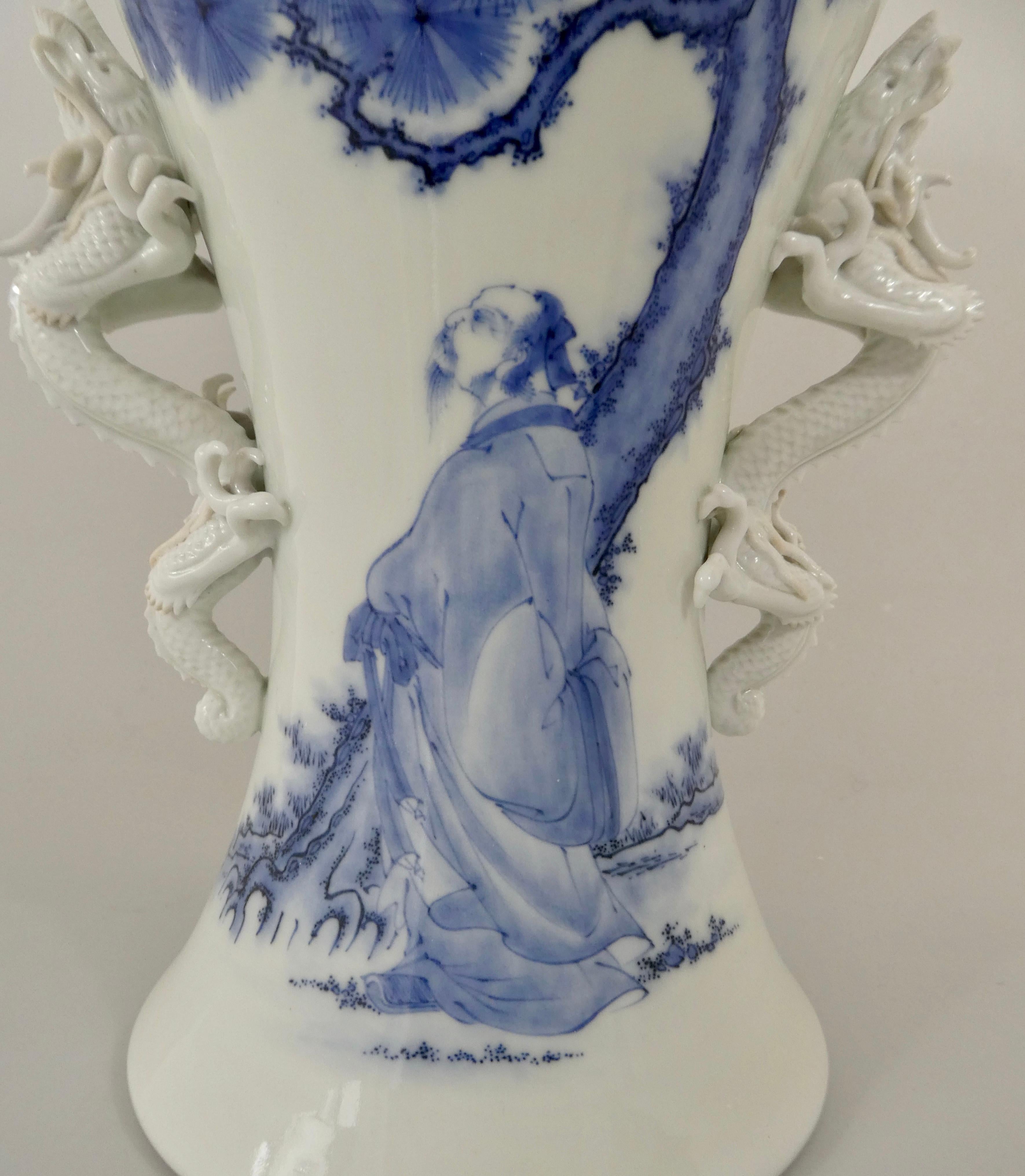 A fine Hirado porcelain vase, Japanese, c. 1870. Meiji Period. Painted in underglaze blue, to the front, with a scholar, contemplating life, whilst stood beneath a large pine tree. The reverse with a young boy attendant holding a fan. 
Either side