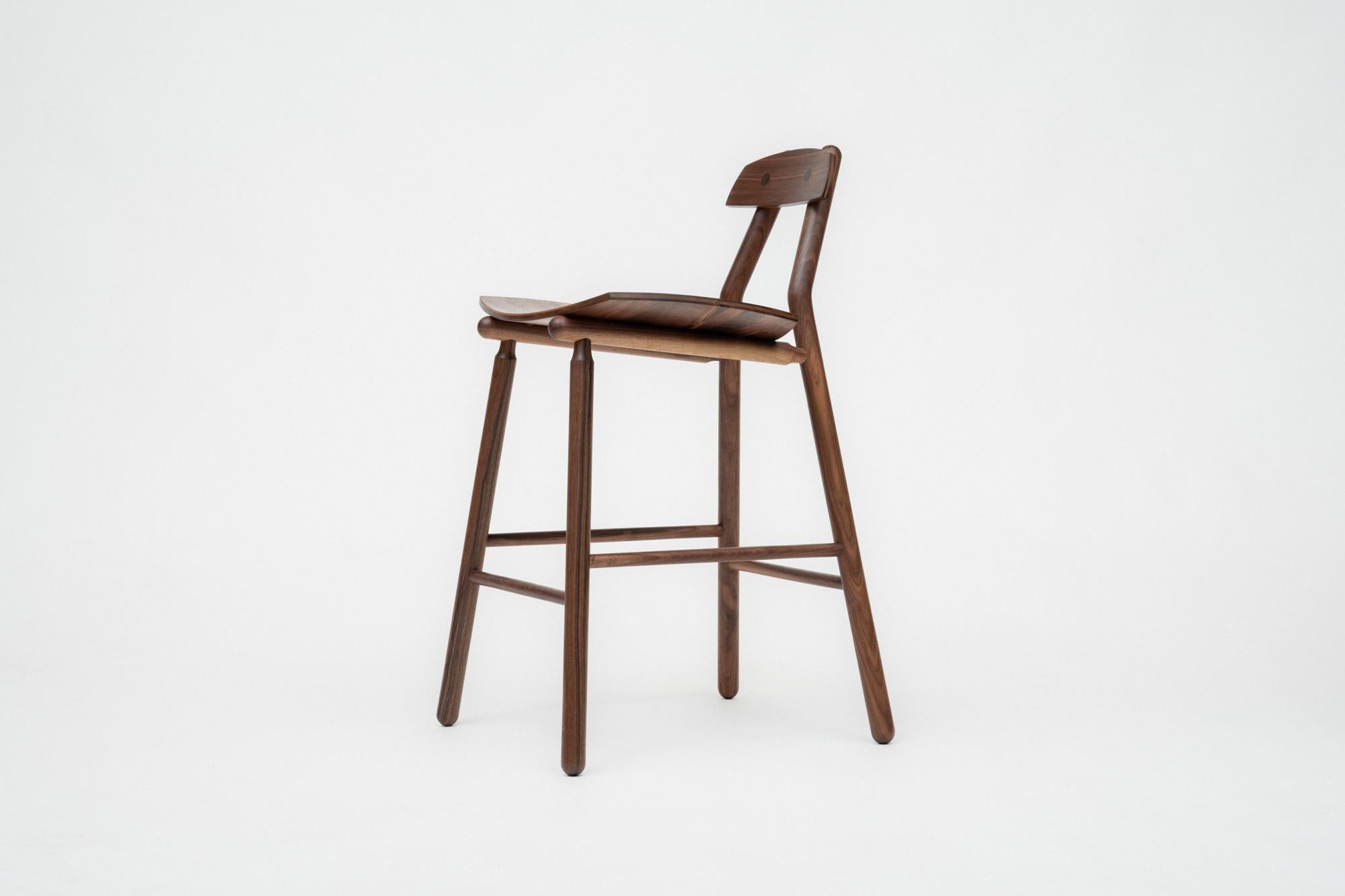 The Hiro Barstool is a contemporary, minimalist design made with traditional methods and solid wood joinery. The seat and back are fabricated from specially milled hardwood with a custom pressed curve that hugs the user. Its light and strong frame