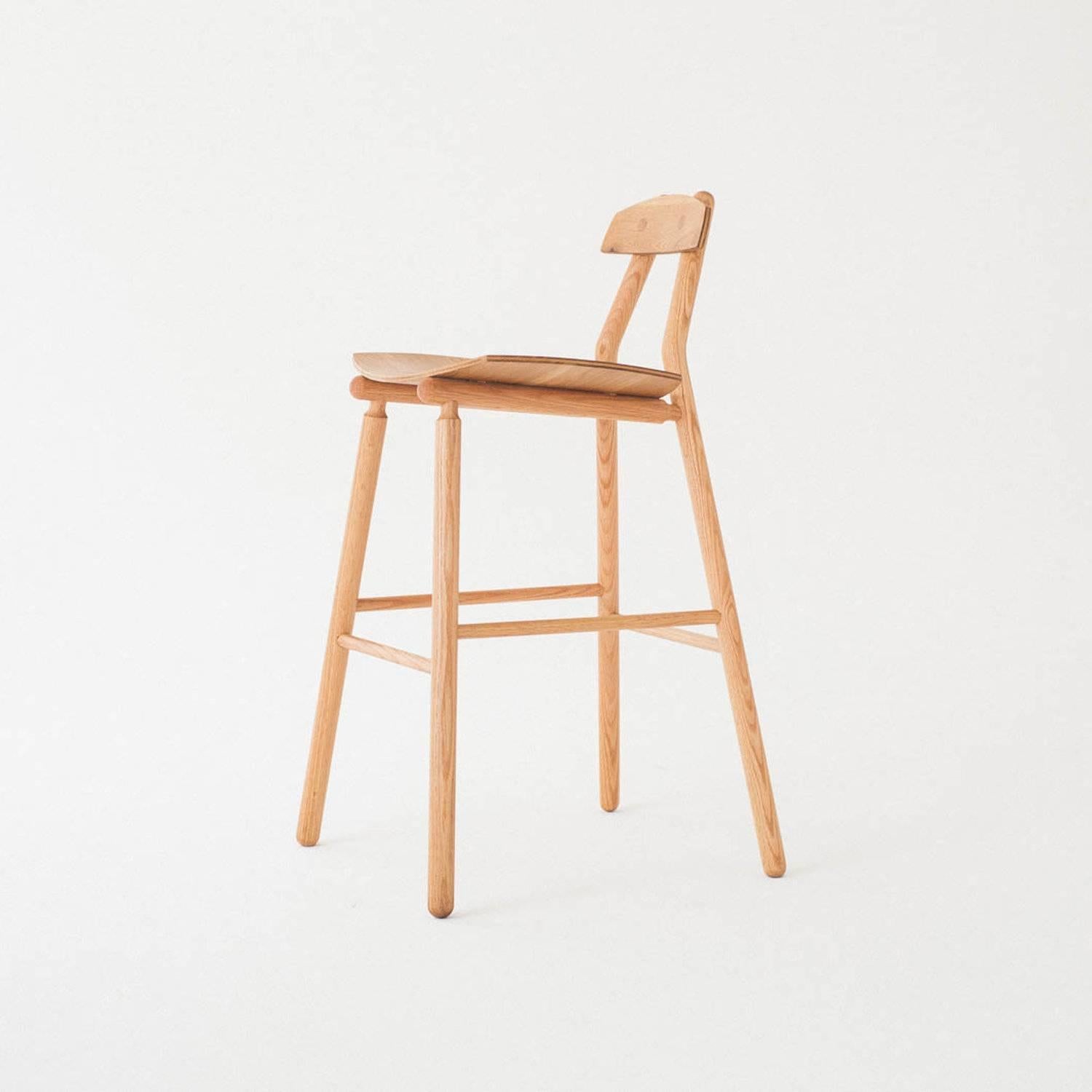 The Hiro Barstool is a contemporary, minimalist design made with traditional methods and solid wood joinery. The seat and back are fabricated from specially milled hardwood with a custom pressed curve that hugs the user. Its light and strong frame
