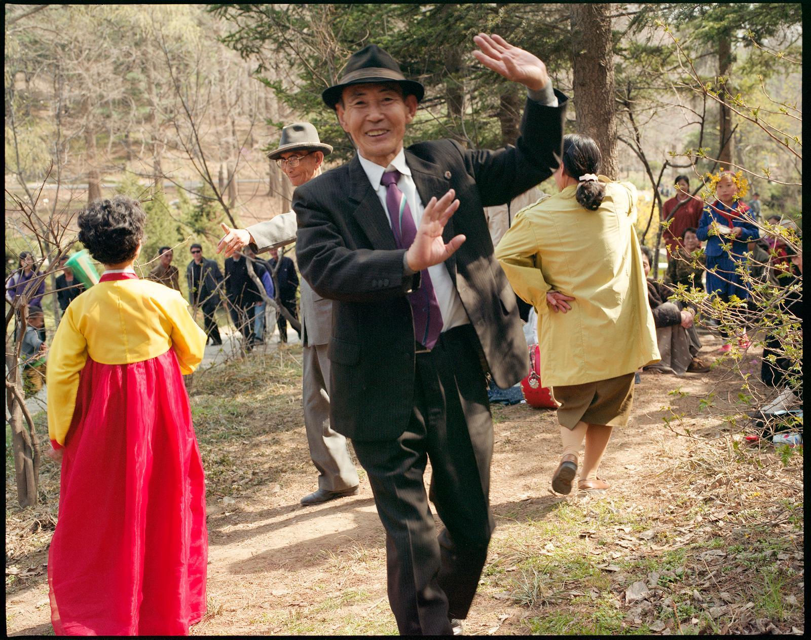 Hiroshi Watanabe Color Photograph - Flower Blossom Party, Morangbong Park, North Korea