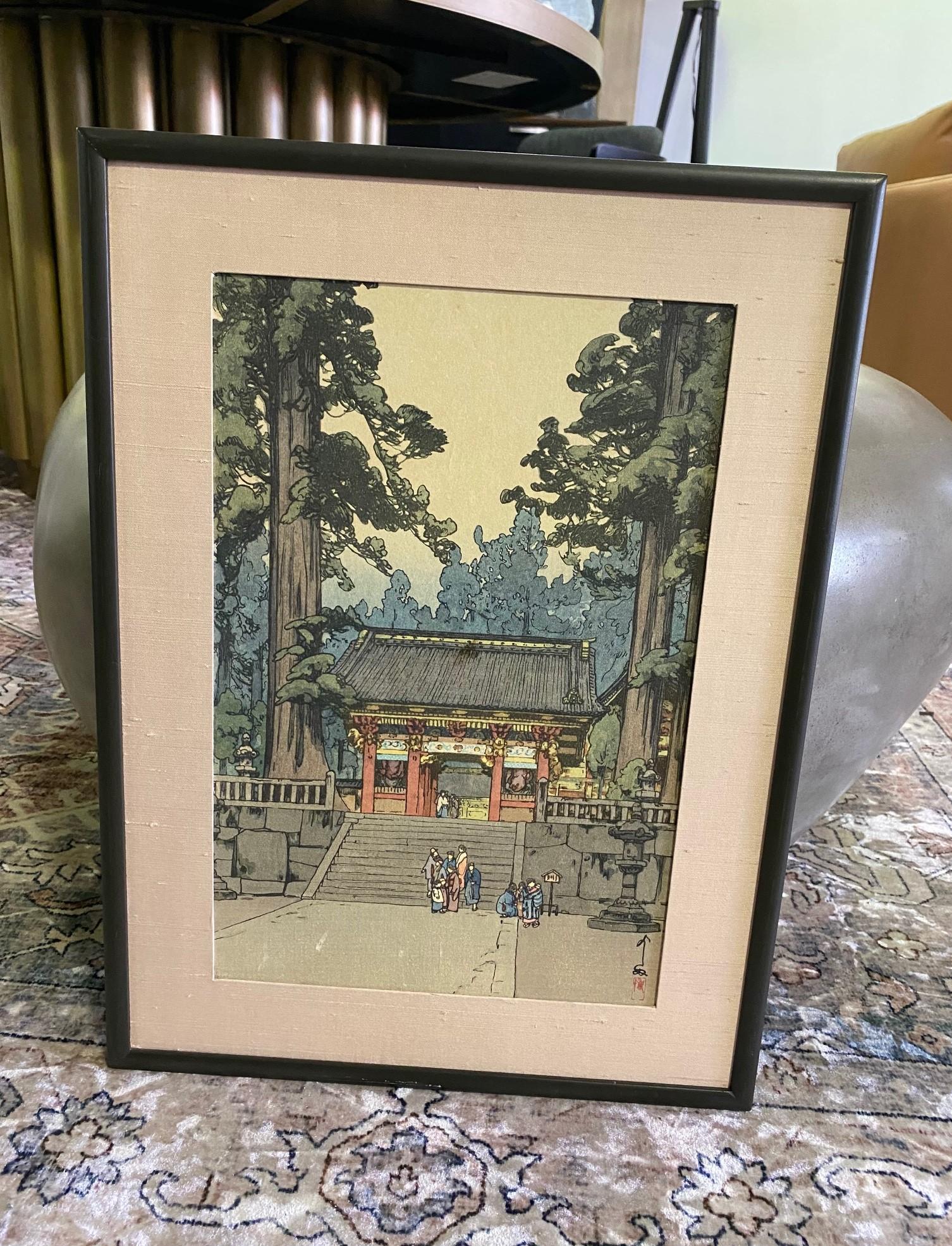 This wonderful image of the Toshogu Shrine in Nikko surrounded by luscious, green forest with various people descending from the shrine steps and gathering in the courtyard is titled 
