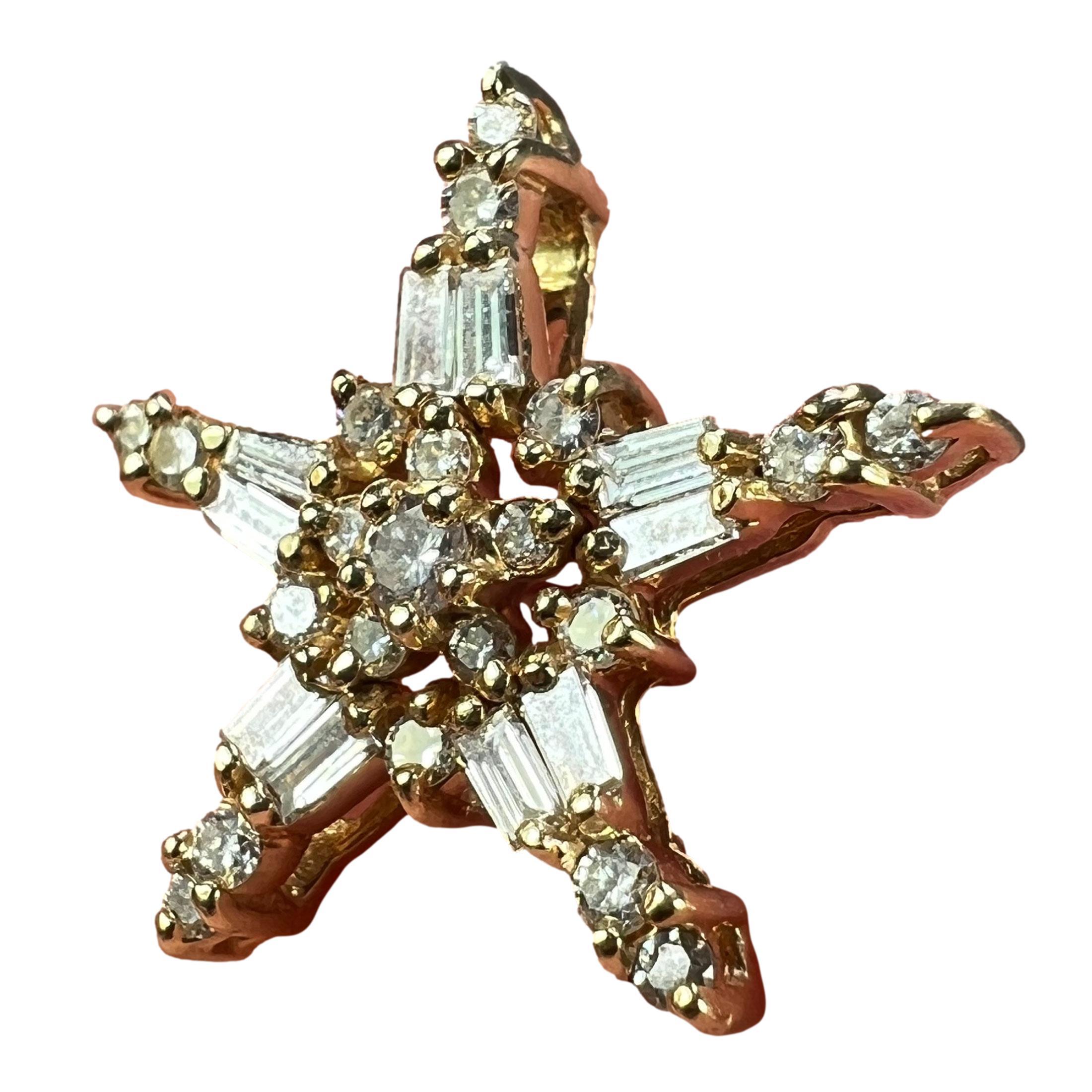 A 14 karat (14K) yellow gold charm pendant designed as five-pointed Christmas star, set with 10 tapered baguette cut diamonds and 21 round brilliant cut diamonds in a range of sizes from 0.01 carats to 0.06 carats with a total approximate weight of