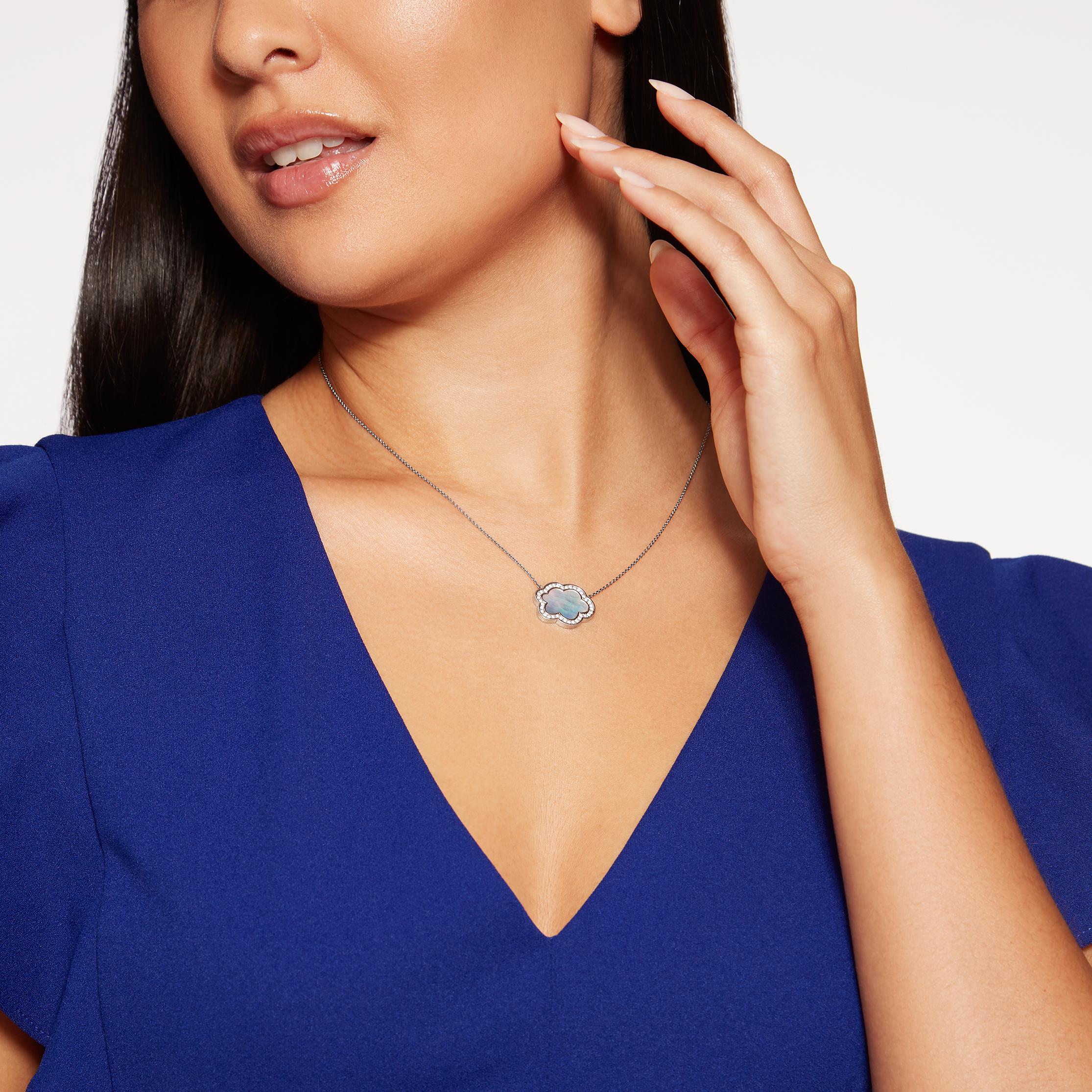 Discover the Hirsh whimsical Cloud 9 collection, inspired by life in London. This beautiful pendant features a central piece of white Mother of Pearl, surrounded by diamonds. The Mother of Pearl is reminiscent of moonlight and casts a magical glow –