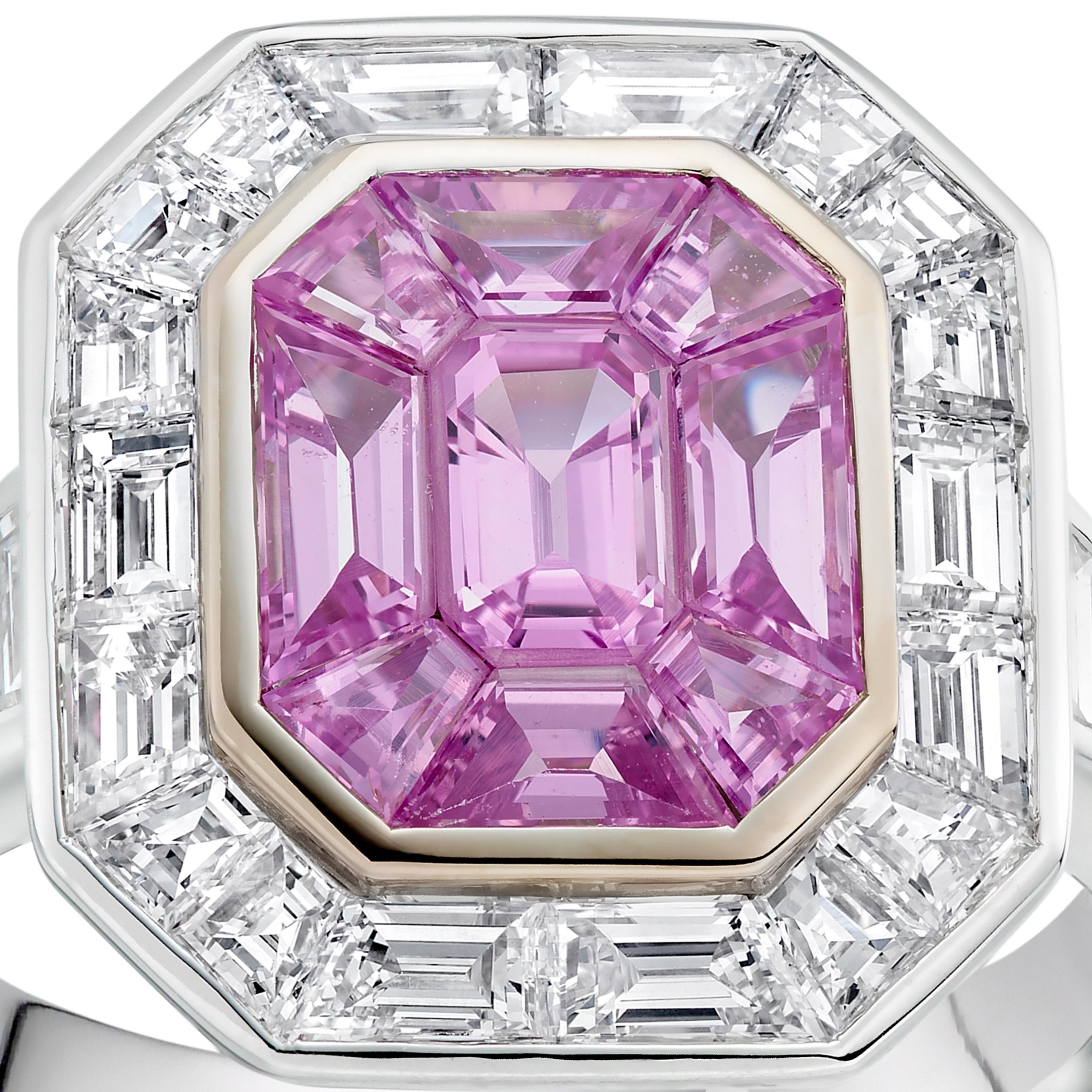 This beautiful pink sapphire cluster ring features 9 vivid pink sapphires weighing approximately 3.45 carats in total, surrounded by a pretty halo of diamonds with further diamonds on the band. The total diamond weight is approximately 1.79 carats.