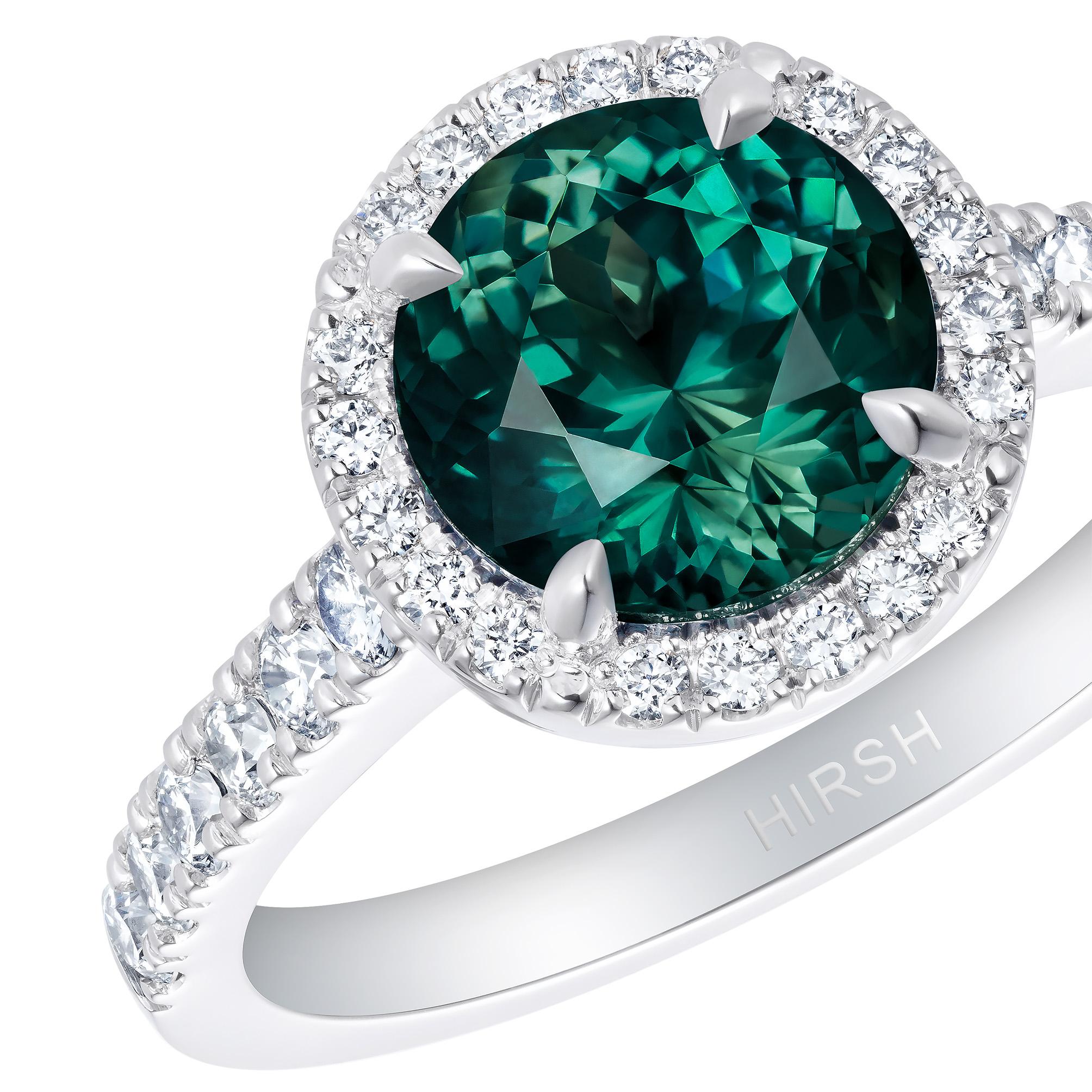 A mesmerising 2.47 carat brilliant cut teal sapphire surrounded by diamonds in the Hirsh Regal setting. This beautiful ring is handmade in platinum and features a total diamond weight of 0.39 carats.

Formed deep within the earth and found on every