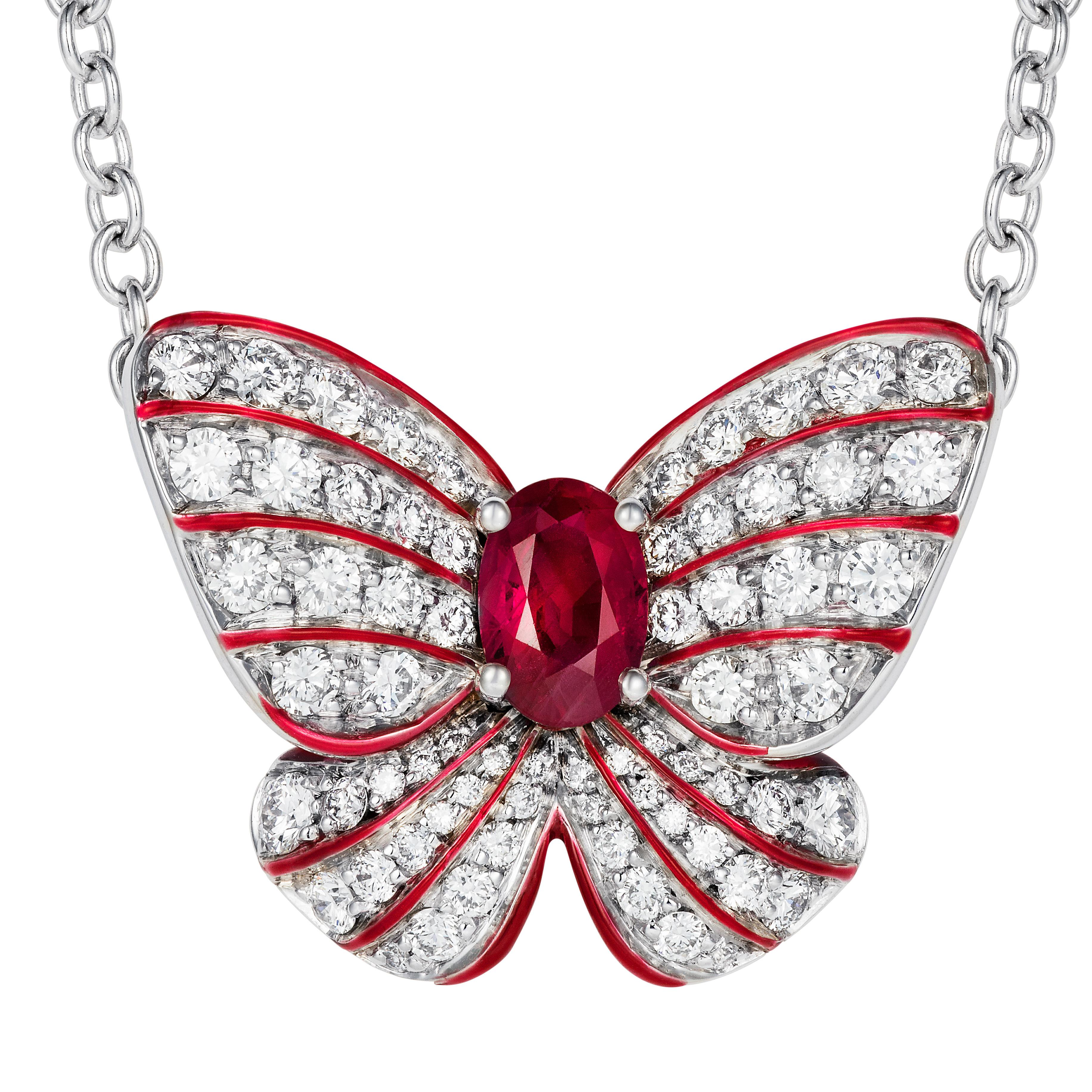A beautiful ruby is set in the heart of a stylised butterfly pendant set with round diamonds with fine red enamel accents.

- 0.50 carat oval shape ruby
- 66 white diamonds totalling 0.73 carats
- Created in 18K white gold, handmade in