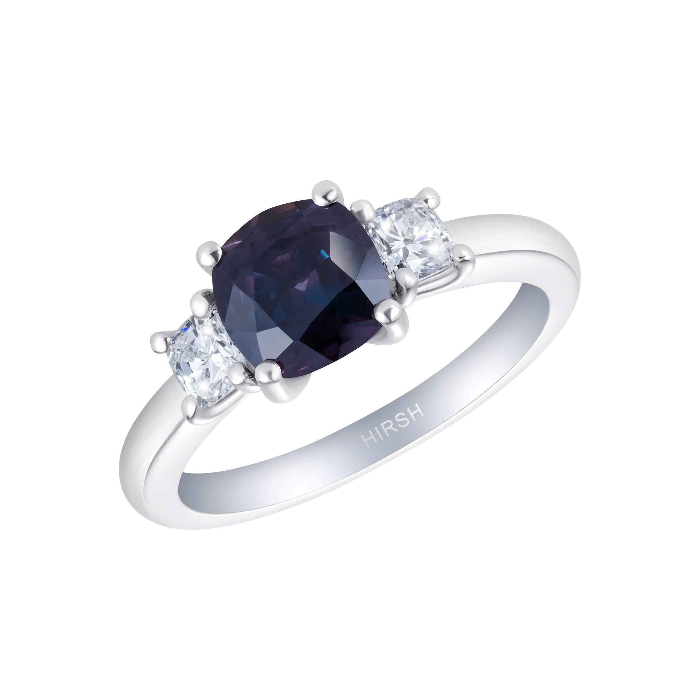 A rare and beautiful colour-change sapphire set amongst two cushion cut diamonds in our Hirsh Trio setting. The sapphire is purple in incandescent light and has flashes of green in daylight.

- 1.83 carat colour-change sapphire
- 2 cushion cut