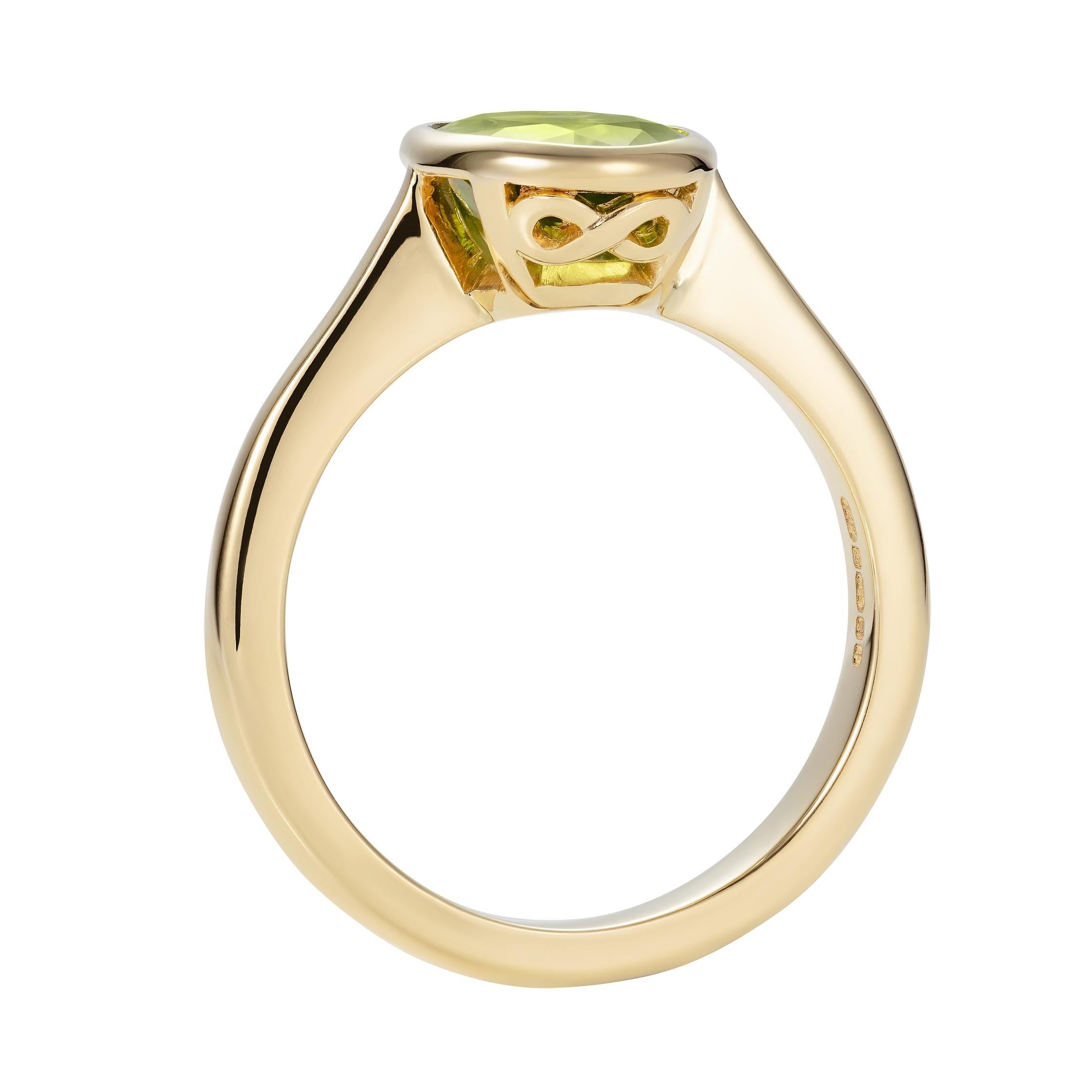 A beautiful oval peridot is harmoniously set in our Hirsh Venus setting with our unique infinity mark on the side.

- 2.12 carat oval peridot
- Created in 18K yellow gold, handmade in London

Formed deep within the earth and found on every
