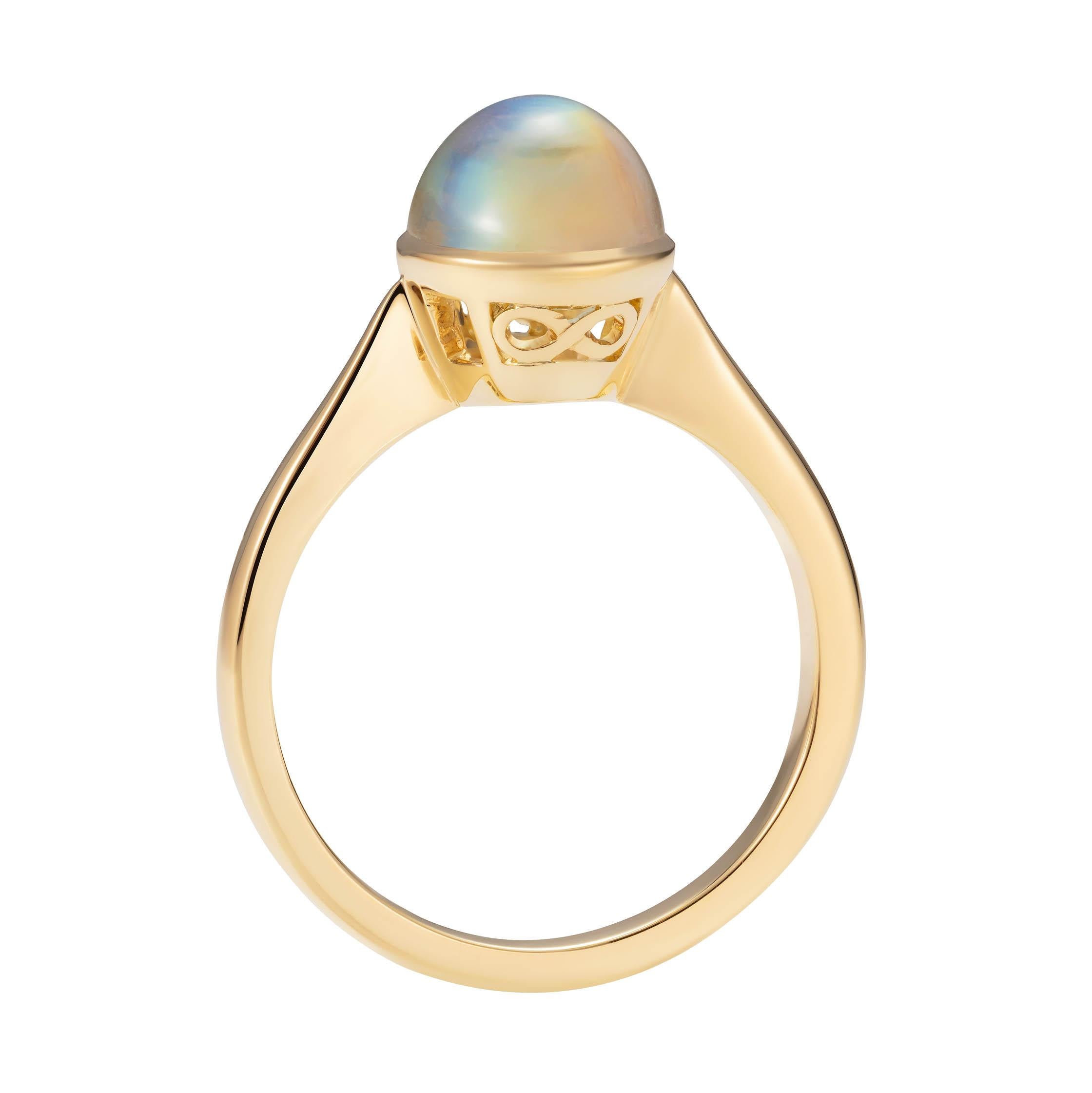 A beautiful rainbow moonstone showing a variety of colours from blue to pink and even soft yellows set in our Venus setting with our infinity mark on the side.

- 1 rainbow moonstone weighing 3.63 carats
- Created in 18K yellow gold, handmade in