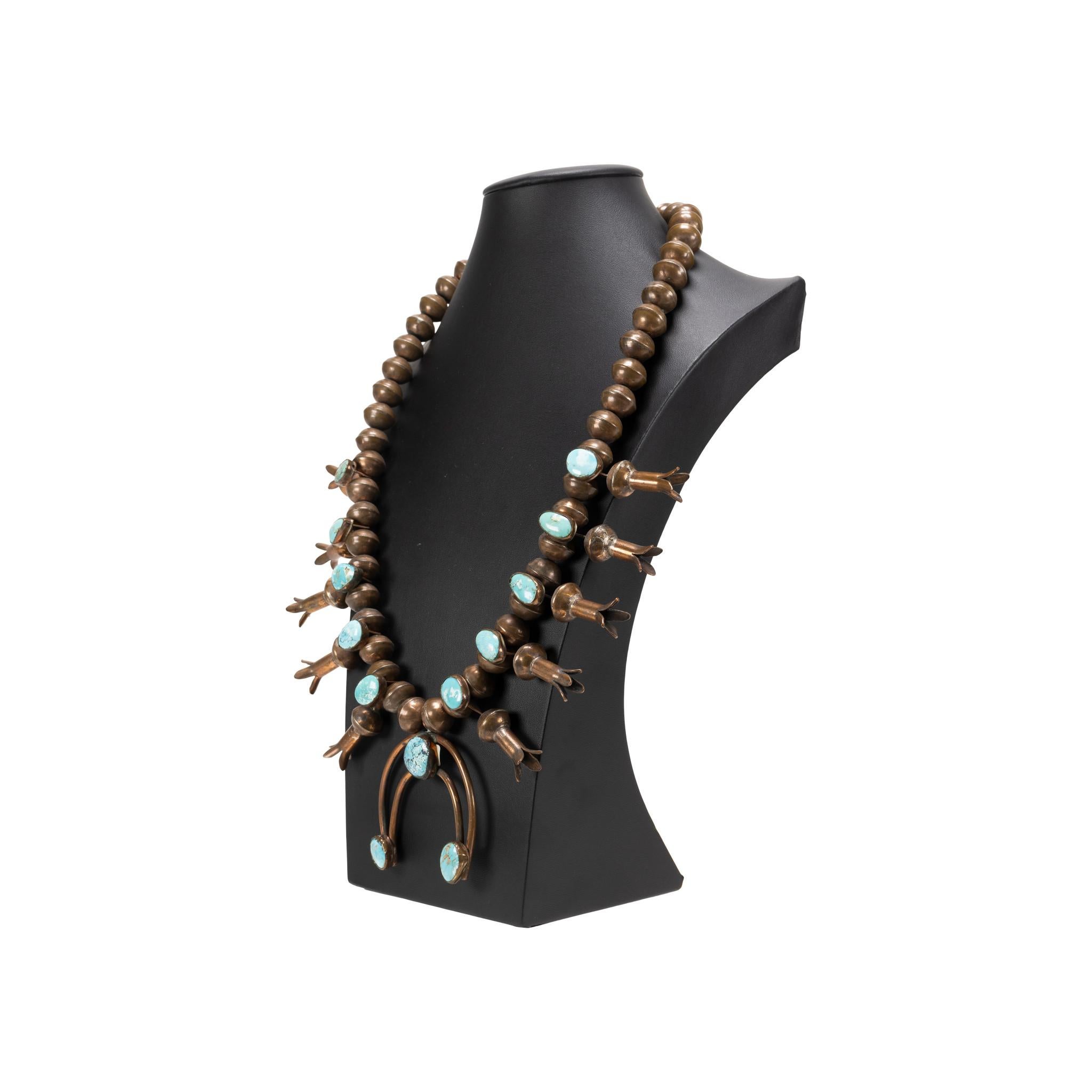 Rare pair of Navajo copper squash blossoms. Made from hammered pennies and exceptional turquoise. Stones are a bright light blue with brown and gold matrix. Purchased from trader Ali Ahmad who acquired from pawn on a reservation. Exceptional and