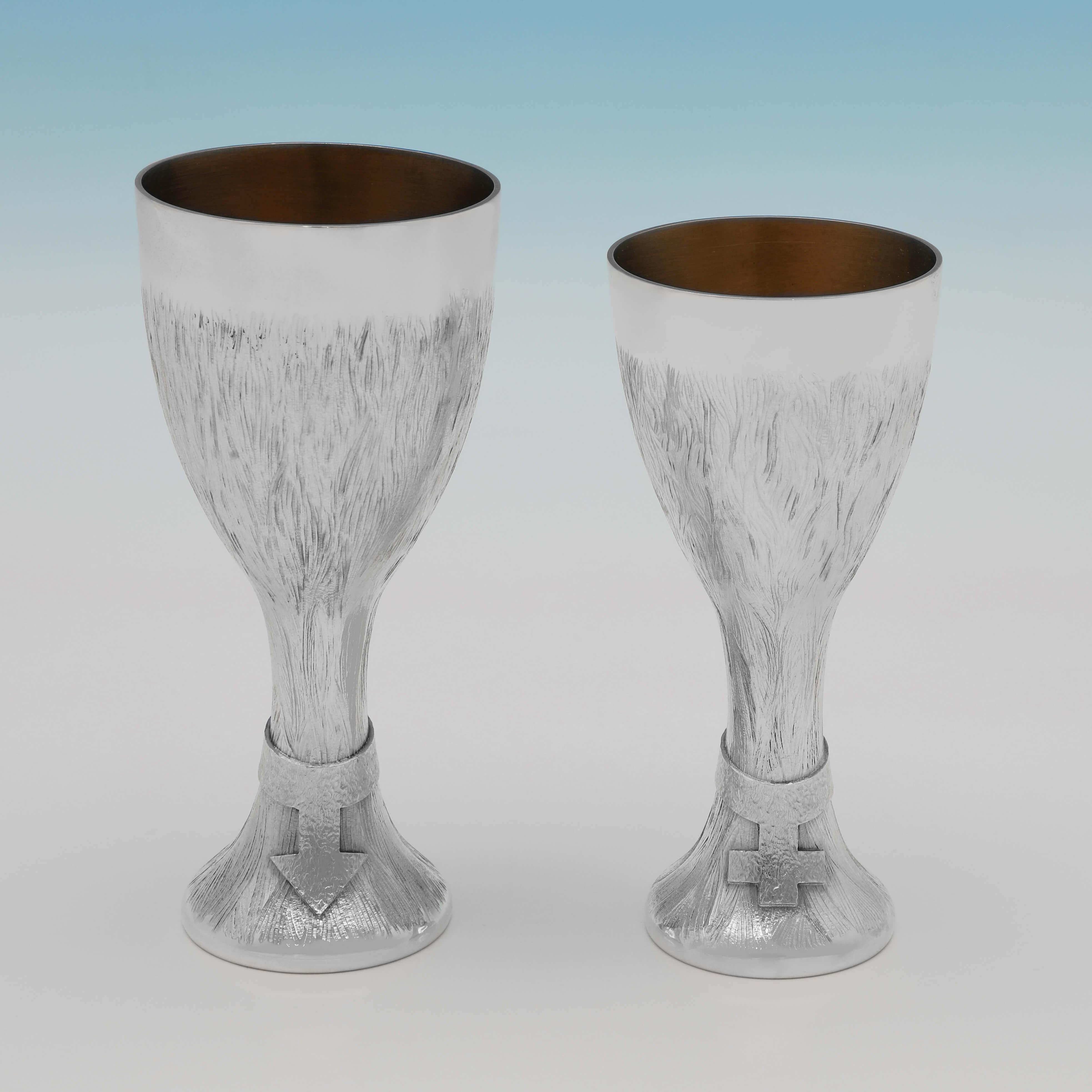 Hallmarked in London in 1974 by Christopher Lawrence, this handsome pair of Sterling Silver Goblets are presented in their original box, and are in Lawrences signature style. The larger goblet measures 5.75
