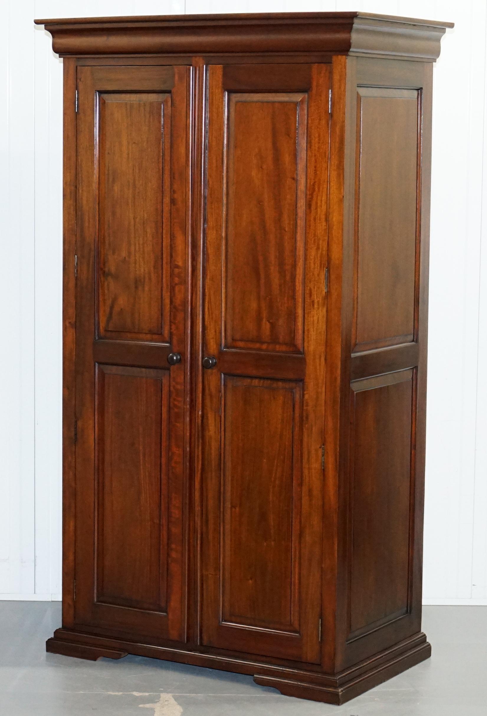 We are delighted to offer for sale this lovely pair of panelled solid mahogany wardrobes

A good looking and well made pair, very utilitarian, very smart, they are ever so slightly different sizes as detailed below but only by 1-2cm's

We have