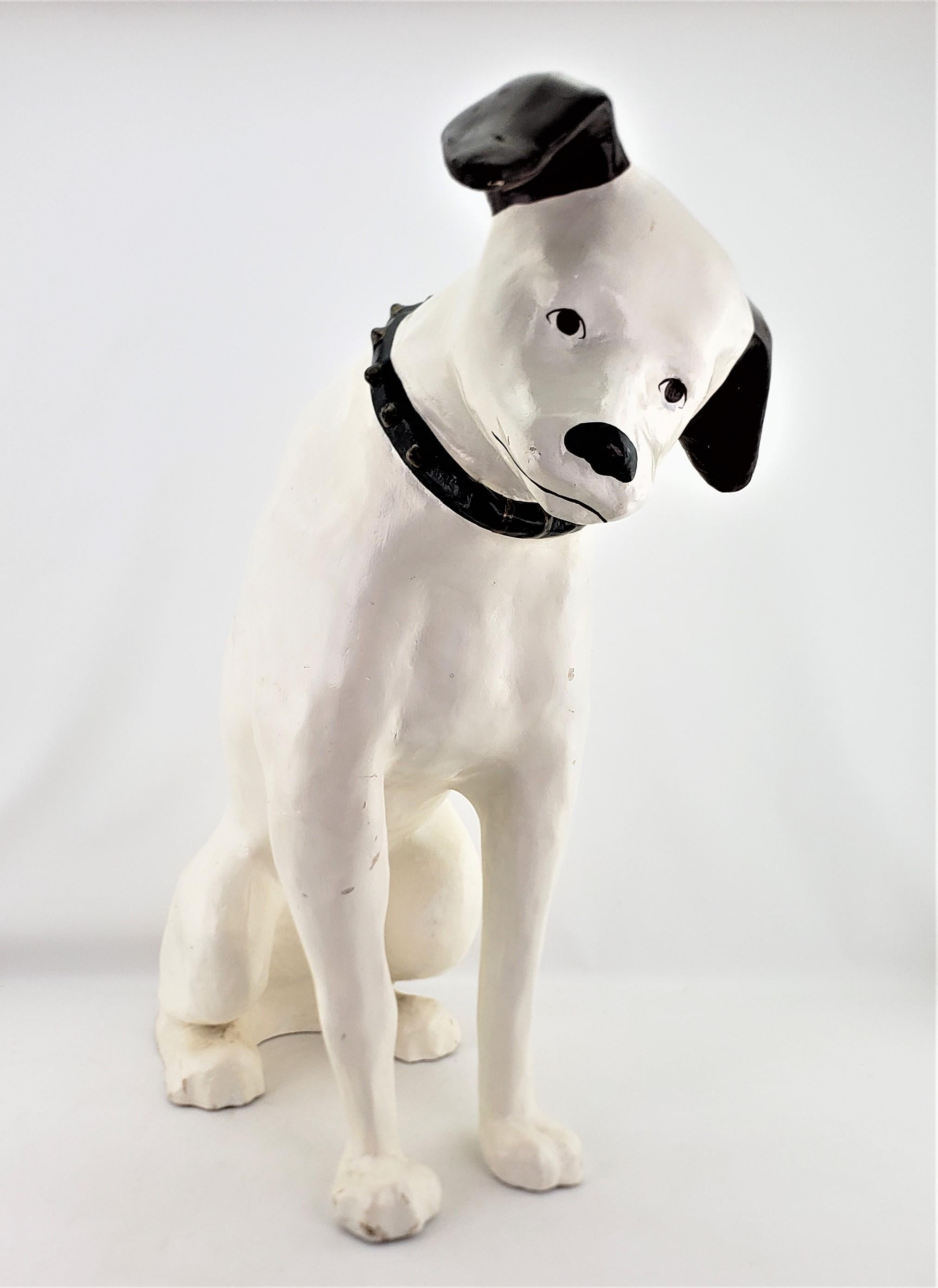 This large advertising store display 'Nipper' dog is unsigned, but being attributed to the Old King Cole Company of Ohio, and dates to approximately 1930 and done in a period Art Deco style. The sculpture is done entirely of a molded paper mache