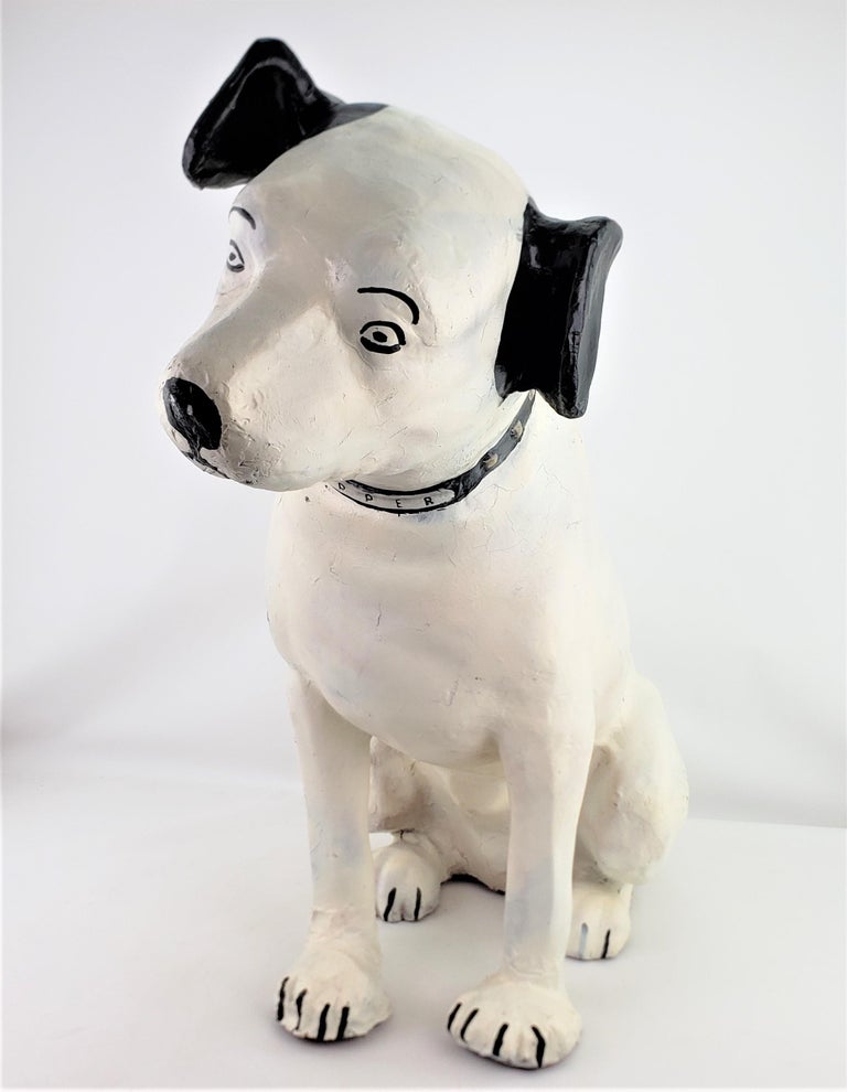 This large advertising store display 'Nipper' dog was made by the Old King Cole Company of Ohio, and dates to approximately 1920 and done in a period Art Deco style. The sculpture is done entirely of a molded paper mache which has been hand painted