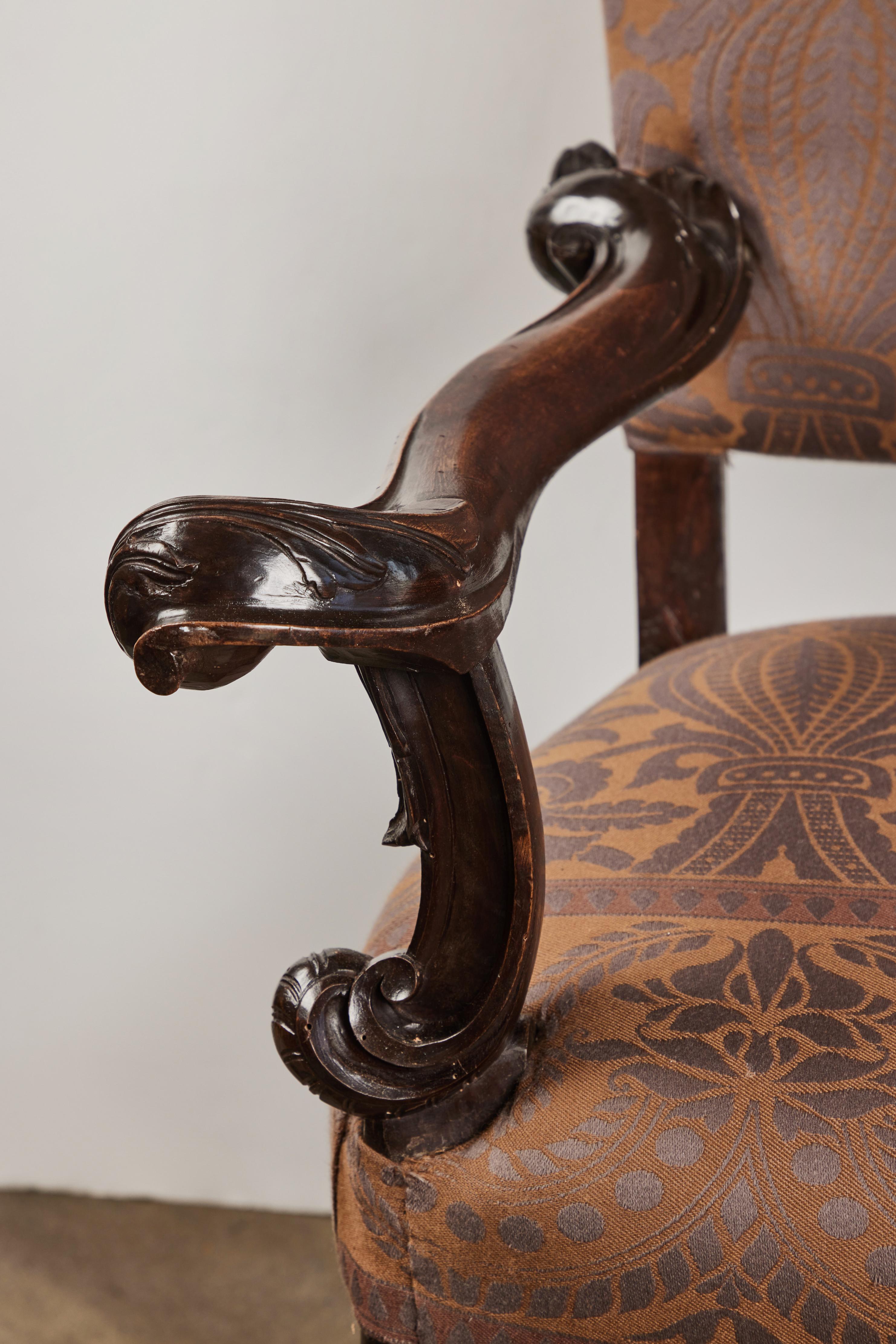 A richly carved walnut Venetian arm chair.  This is the 
