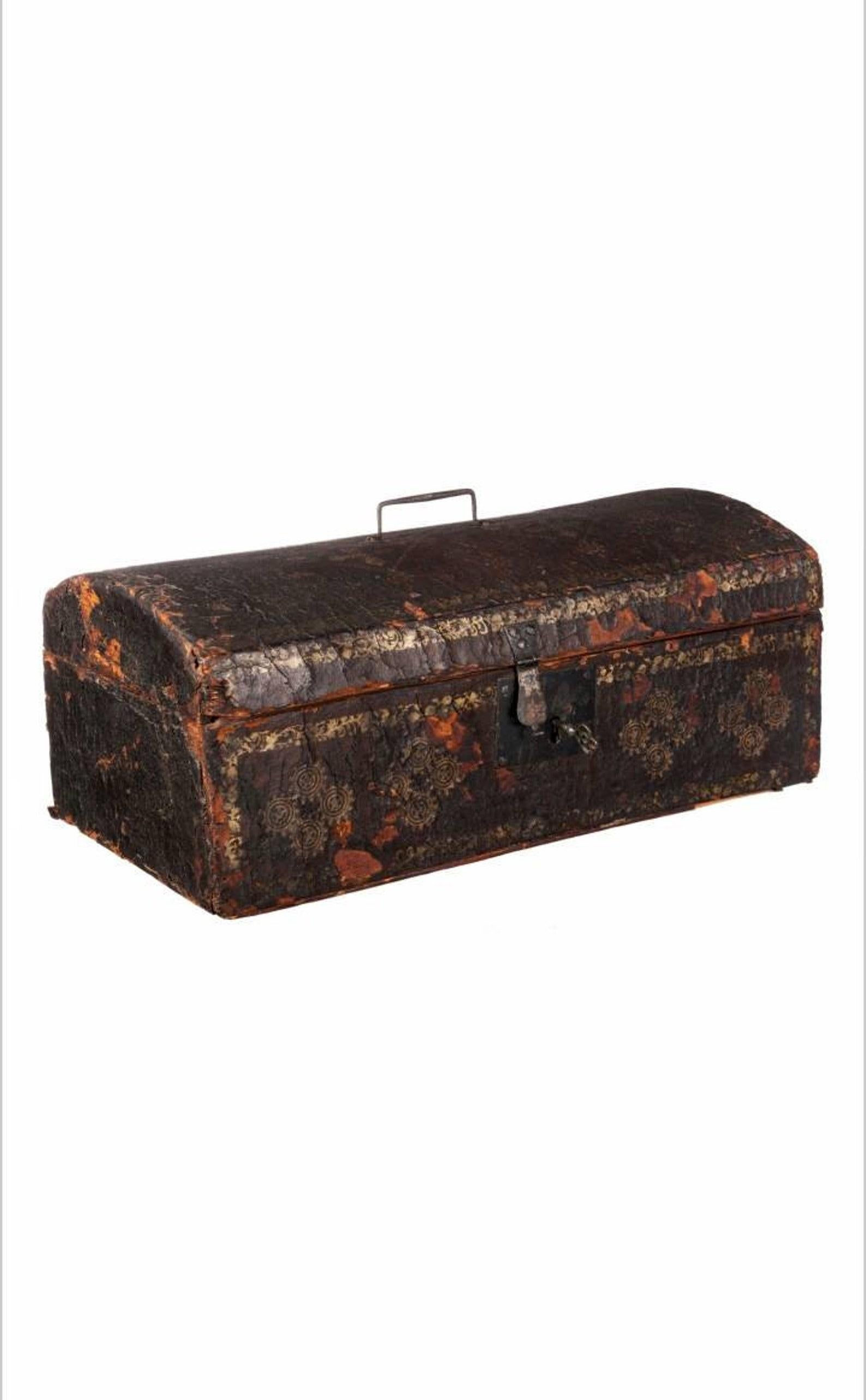An important historic Long Island 18th Century document box, American Revolution era, having a rectangular chest with dome shaped hinged lid, wrapped in the original naturally distressed hide covering with gilt gold-leaf decoration, original lockset