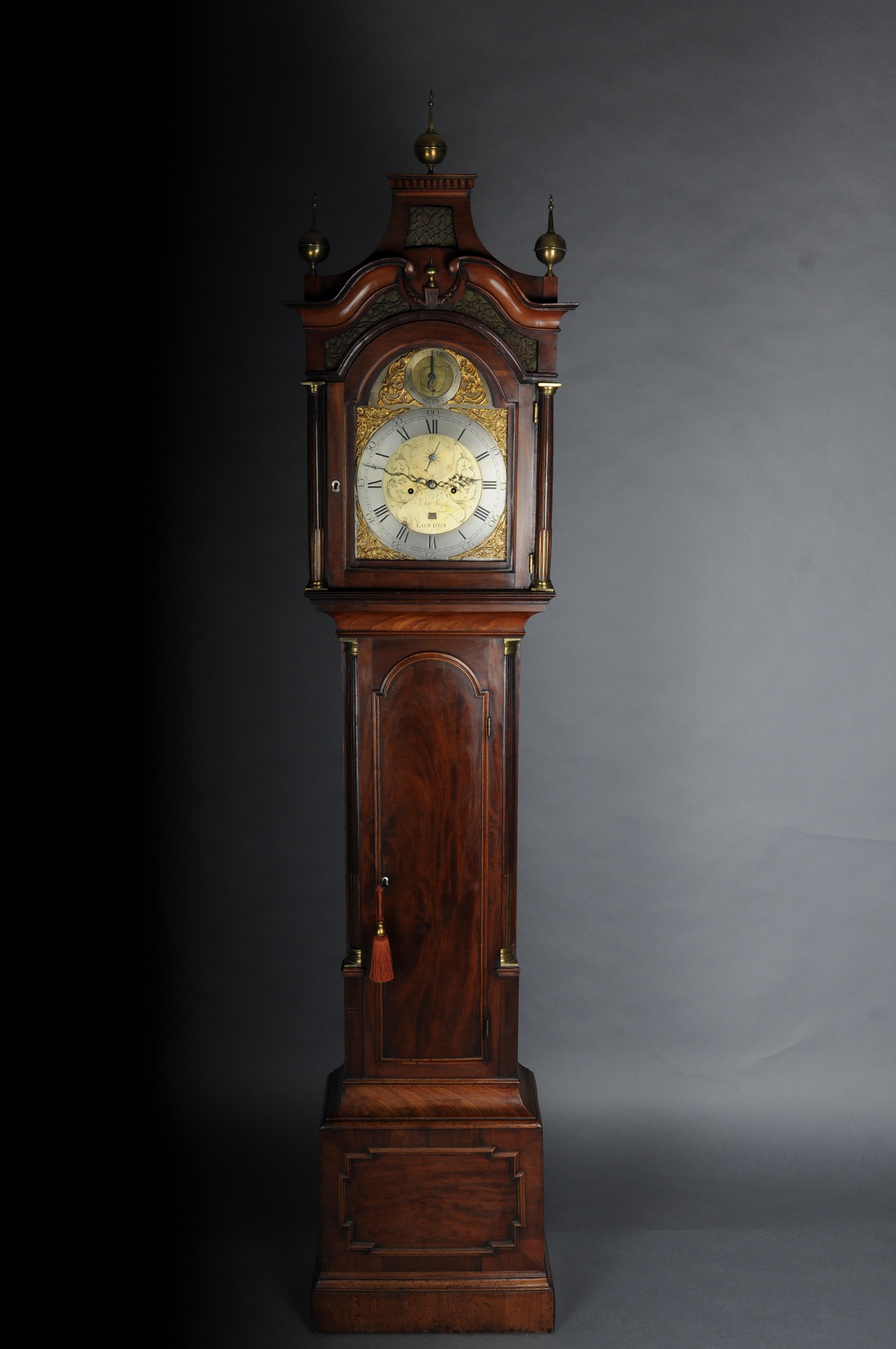 Historic antique English grandfather clock, mahogany, 18th century.

English grandfather clock, 18th century, mahogany veneer with burl wood mirror, pearl strips, fluted columns, brass-gilt and finely chiseled dial with Roman numerals and
