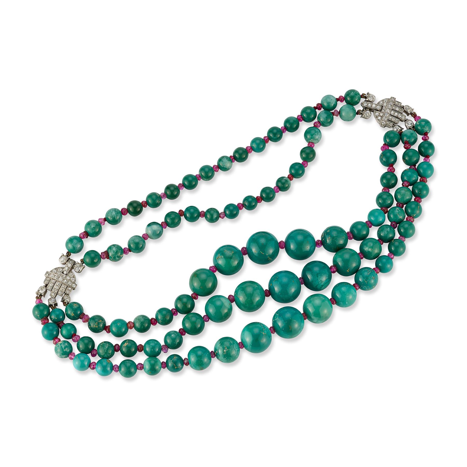 Historic Art Deco Cartier Turquoise and Ruby Bead Necklace

This superb necklace made circa 1925 set with 3 rows of graduating turquoise beads set with ruby bead spacers.
2 diamond set platinum clasps 2 back rows of turquoise beads with ruby