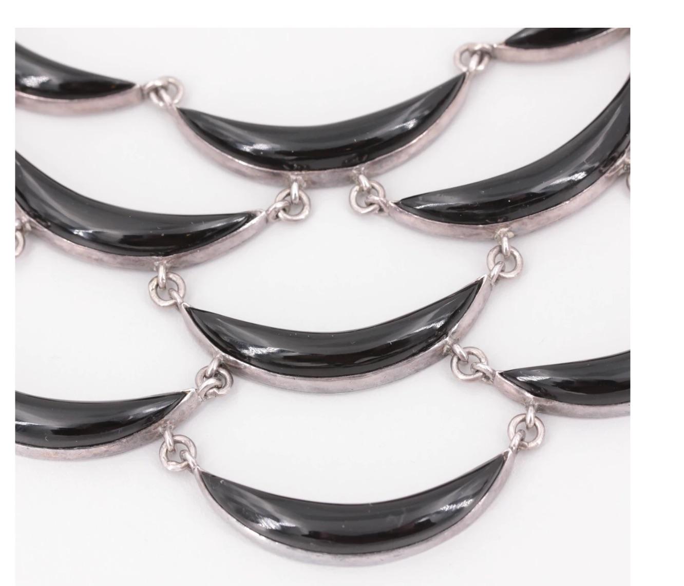 This Modernist vintage signed and Hallmarked Museum Collectible Sterling Silver and obsidian Crescent Collar necklace and dangle earrings set are one of Antonio Pineda's iconic designs from the 1950's! 

Fabricated of 970 sterling silver, it
