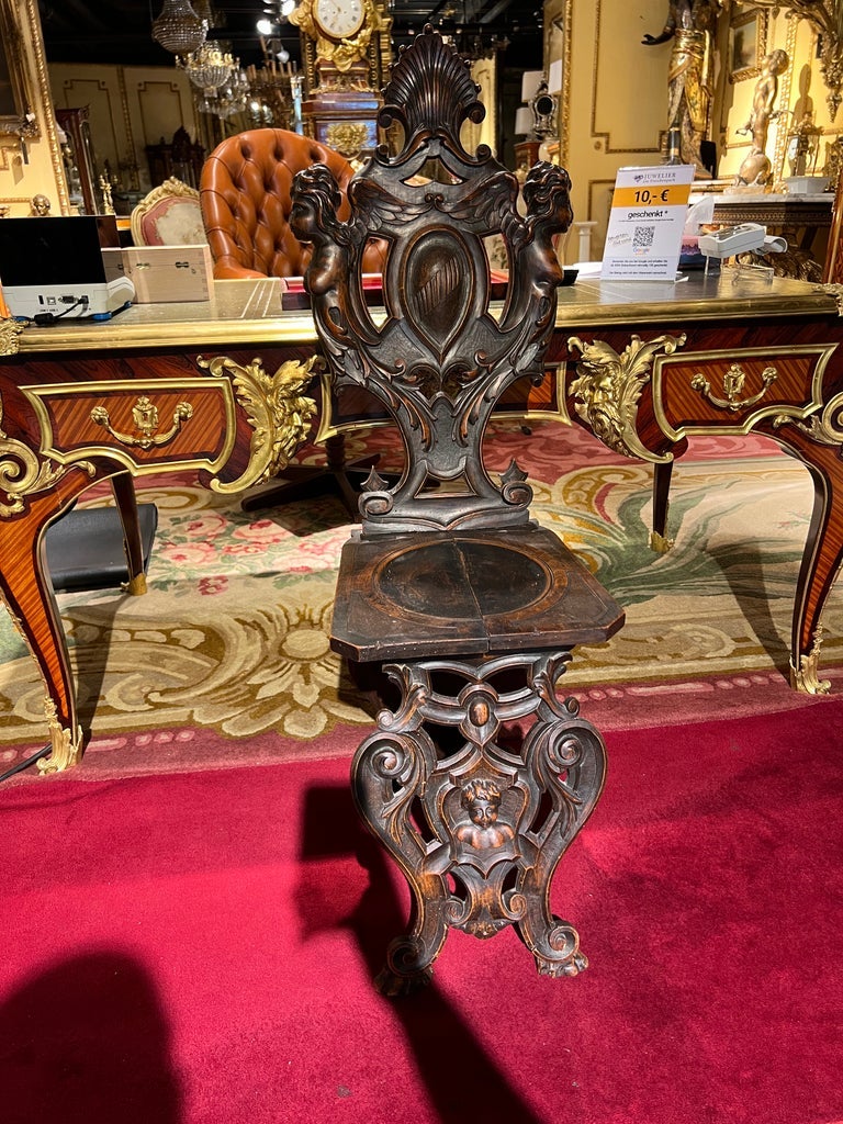 Board chair, late 19th century, solid walnut, carvings typical of the time in semi-sculptural design