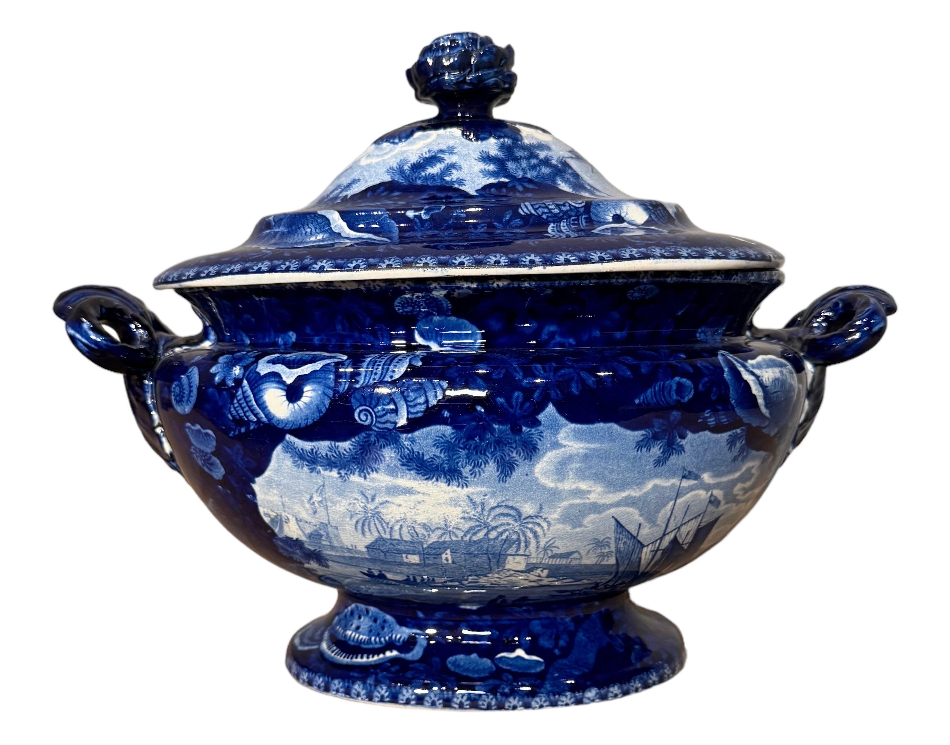 Historical Blue & White Staffordshire Soup Tureen/ Dix Cove on the Gold Coast of Africa, 19th Century
Historical Staffordshire blue soup tureen with a view of” The Dix Cove On The Gold Coast of Africa” from Enoch Wood & Sons Irregular Shell border