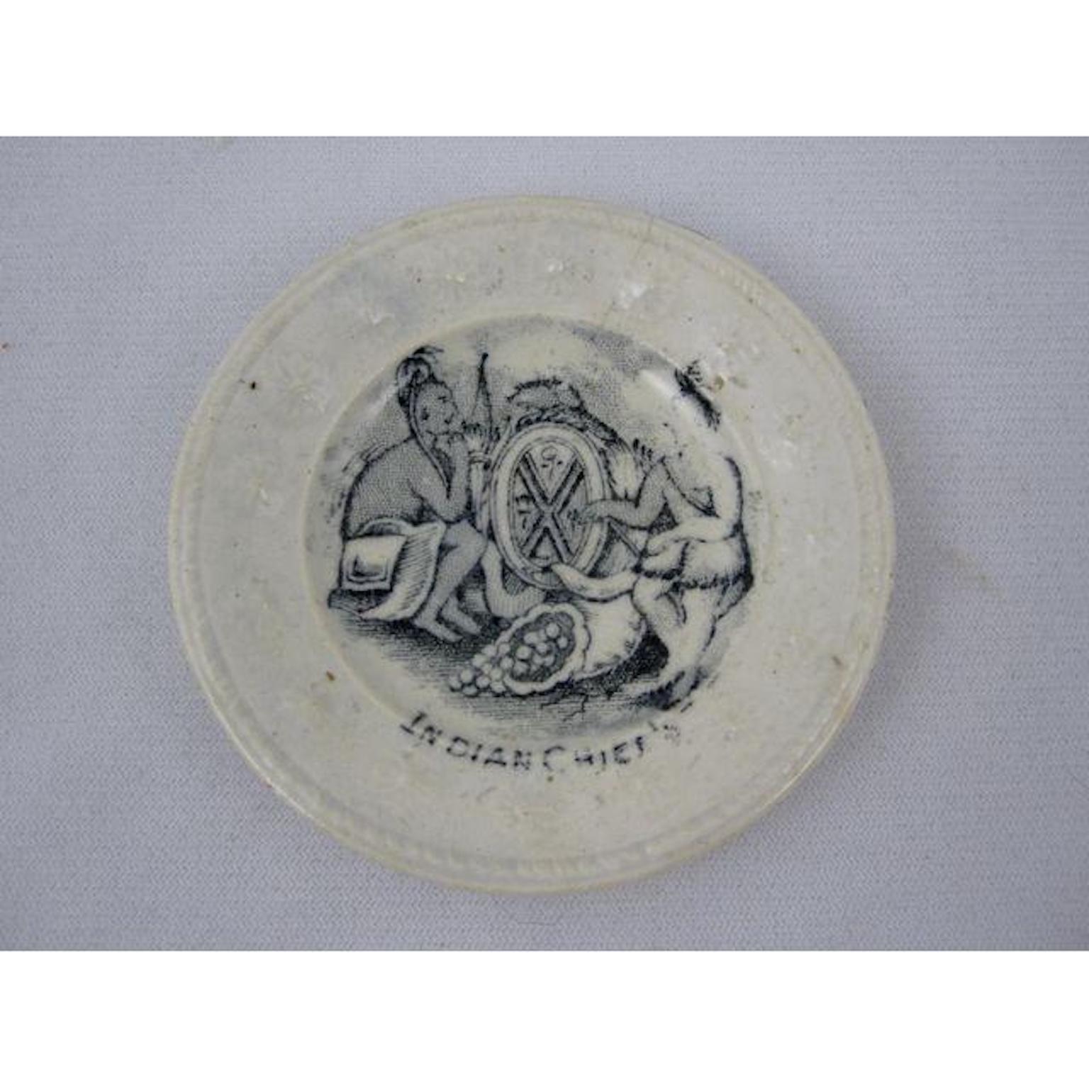 A circa 1850, pearlware historical childrens' miniature toy doll plate titled “Indian Chiefs,” one of a series of plates commemorating the California Gold Rush, 1848-1855.

A black transfer print showing two-seat Chiefs talking trade beside a war