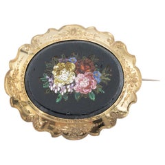 Historical gold brooch with floral micromosaic on onyx.