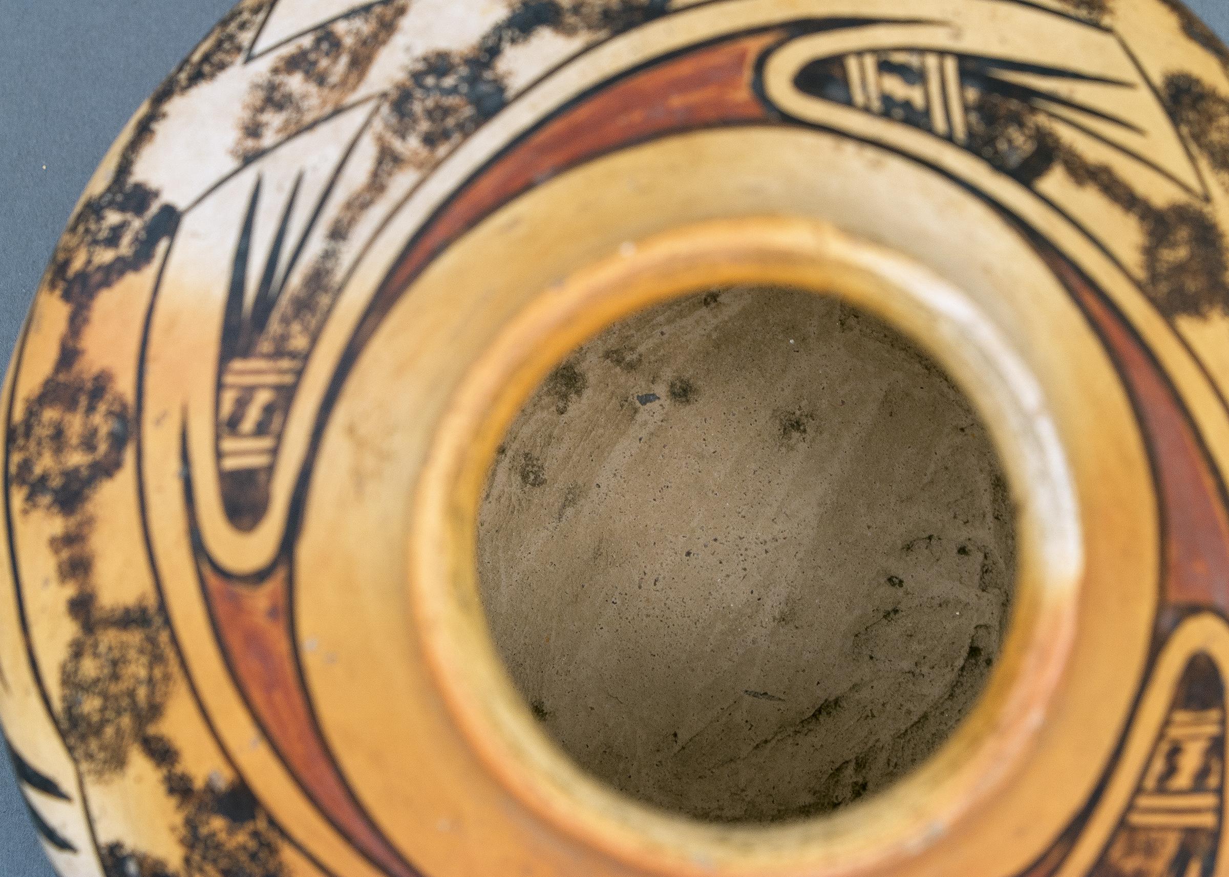 Pottery Seed Jar crafted by hand and meticulously painted in slip glazes, attributed to renowned Hopi potter, Nampeyo (1860-1942). The polychrome (three-color) design includes stylized bear claw design elements.
 