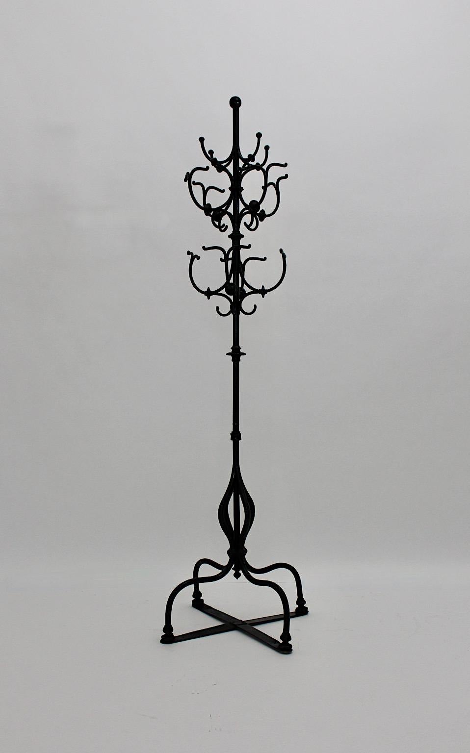 Historicism antique vintage coat rack or coat stand from black lacquered cast and hammered iron circa 1890 Austria
Wonderful and outstanding coat rack with many hangers and racks, very stable and sturdy through its weight and four feet base