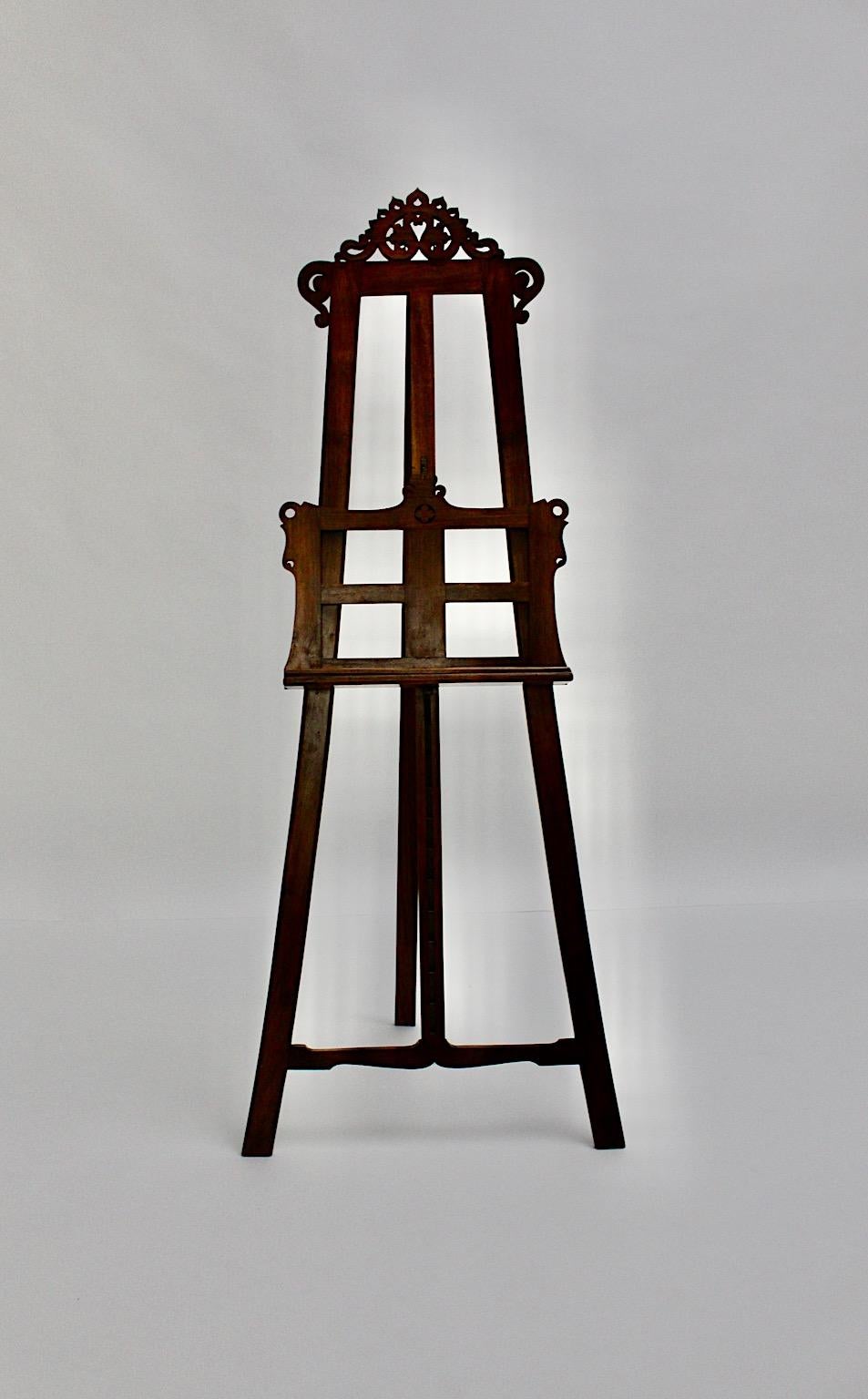 Historicism Neorokoko handcrafted vintage easel from solid walnut and brass details circa 1870 Austria.
The wonderful easel in the style of baroque is adjustable to height till 110 cm, which allows to show paintings in many various sizes. The rack